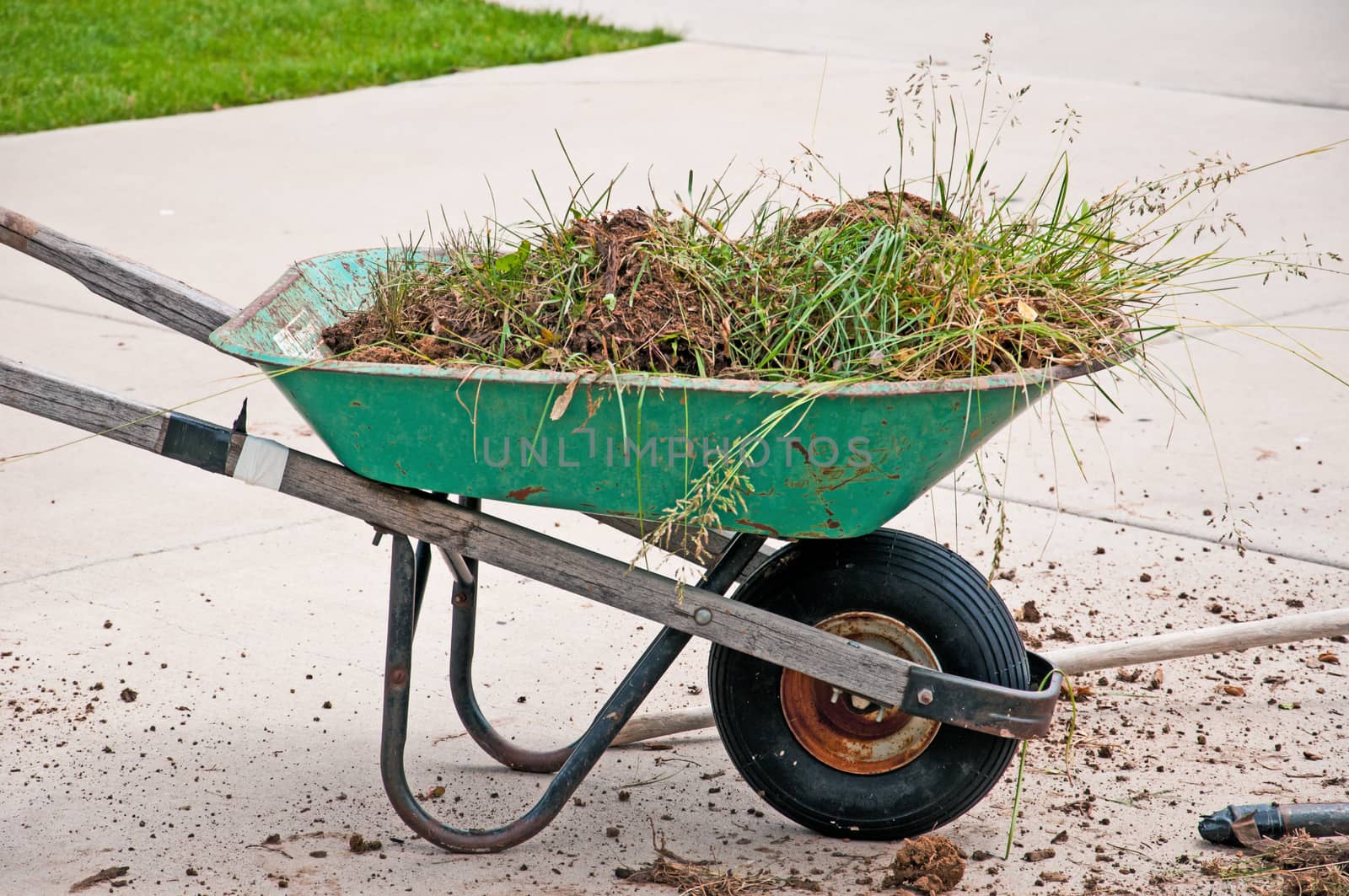 Old wheelbarrow still giving service after many years performing yardwork.