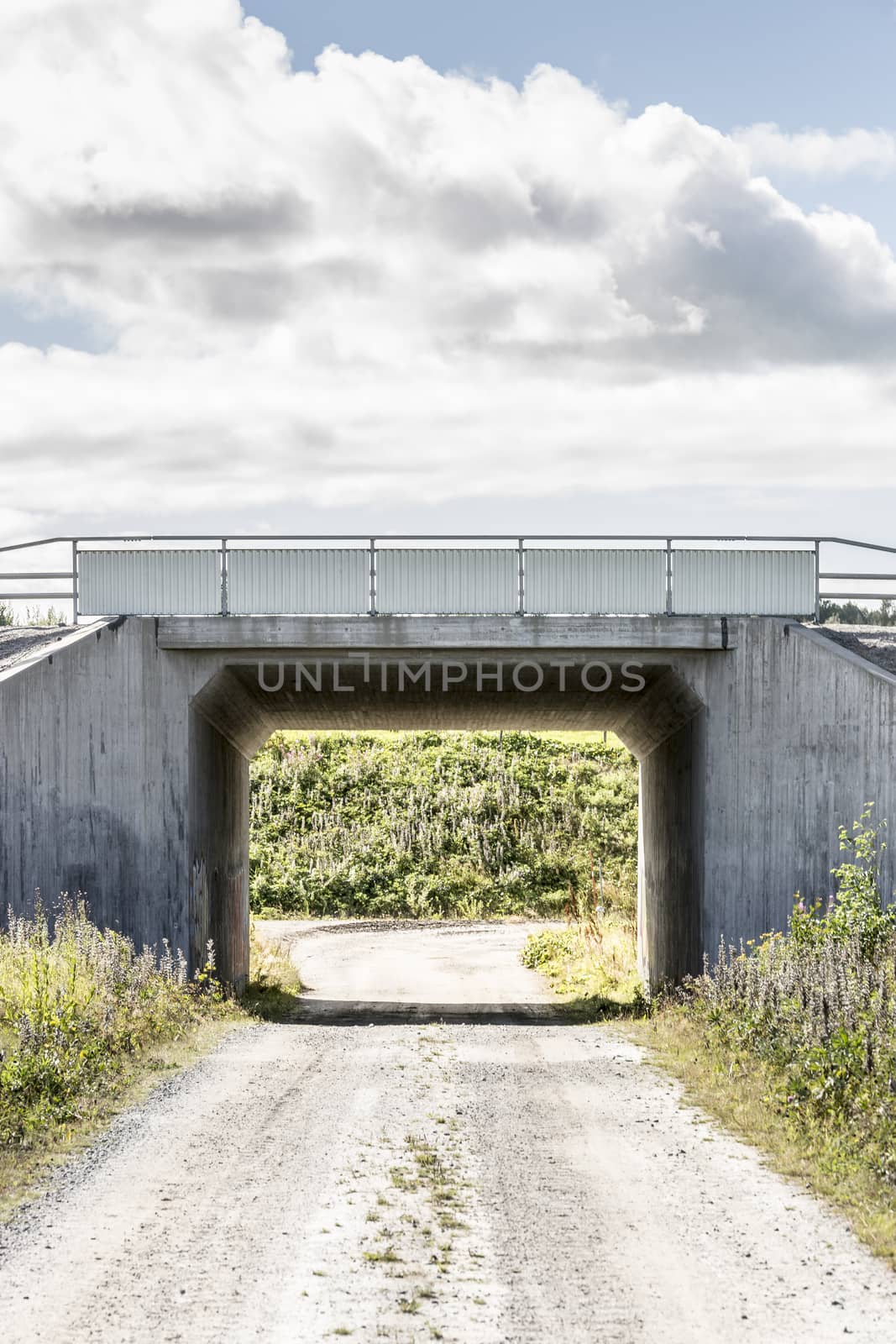 Tunnel Under Road with a cloudy sky.