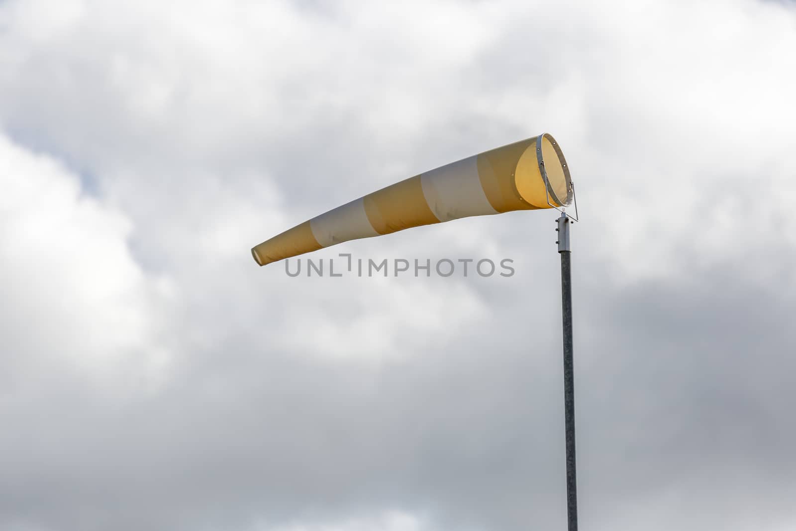Wind Direction Indicator with a cloudy sky.