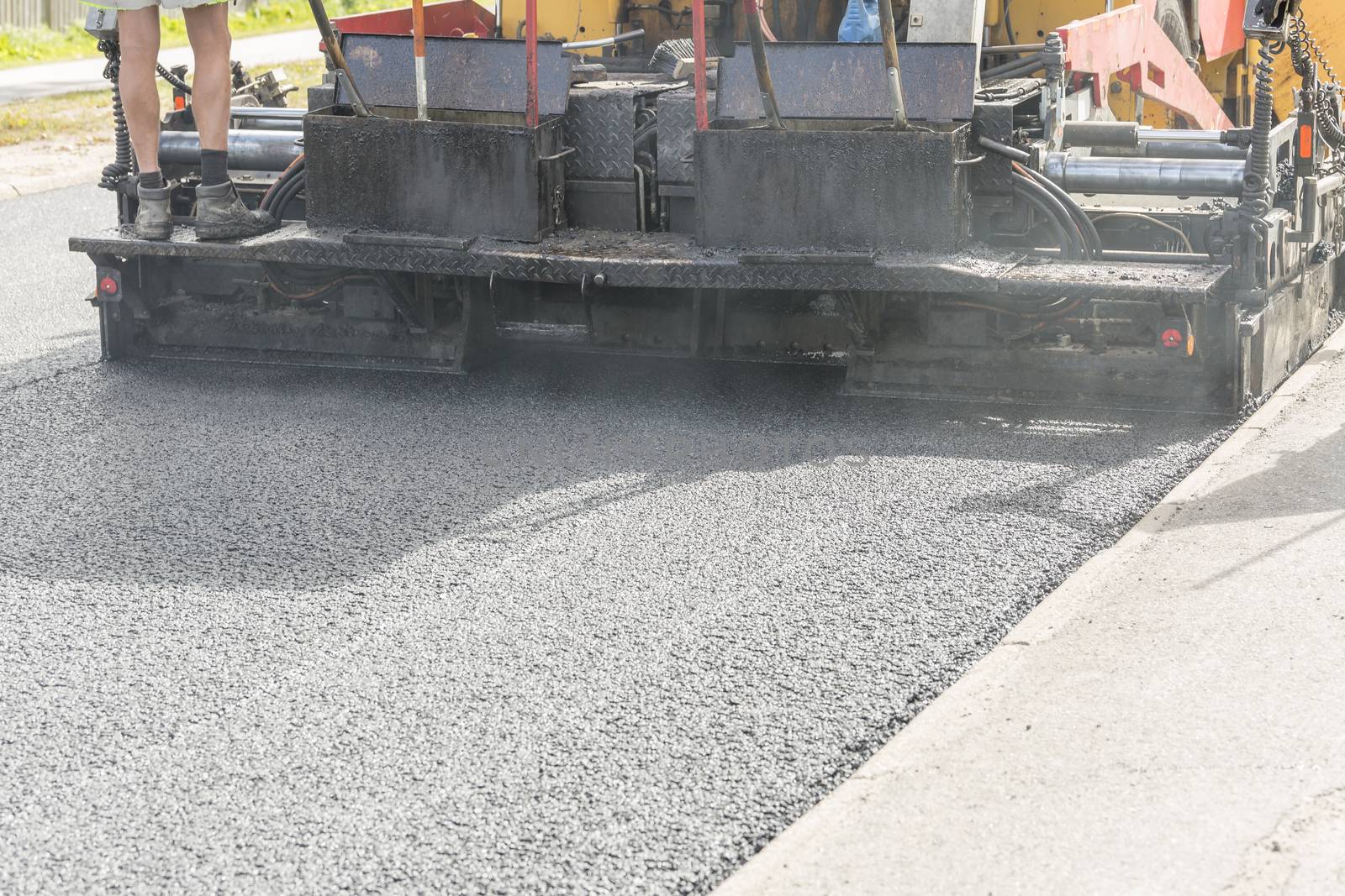Asphalt Paver Laying Down Asphalt close up.