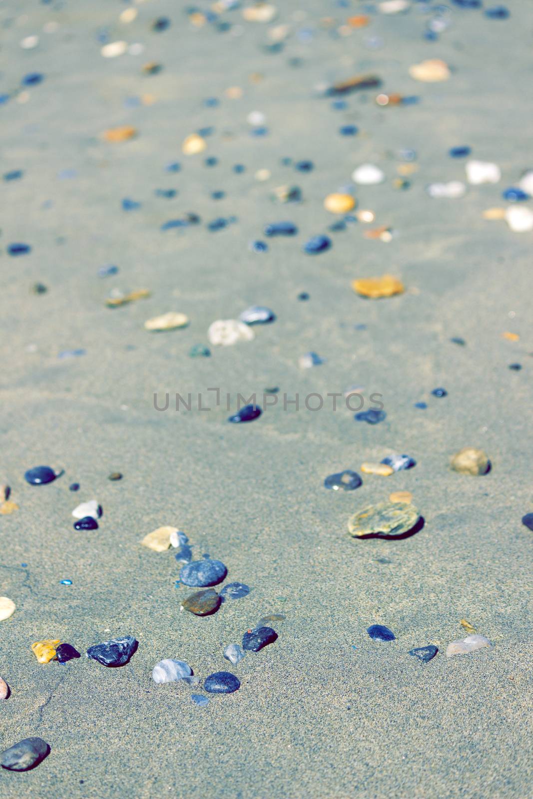 Pebbles on the sandy beach - vintage look