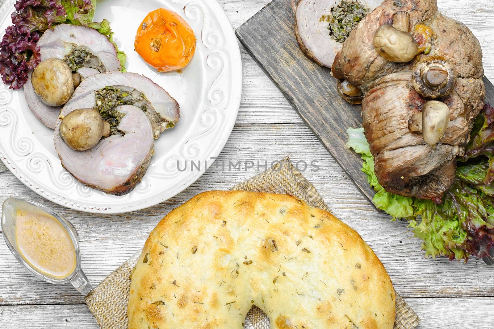 Dining table with meat loaf and pita bread