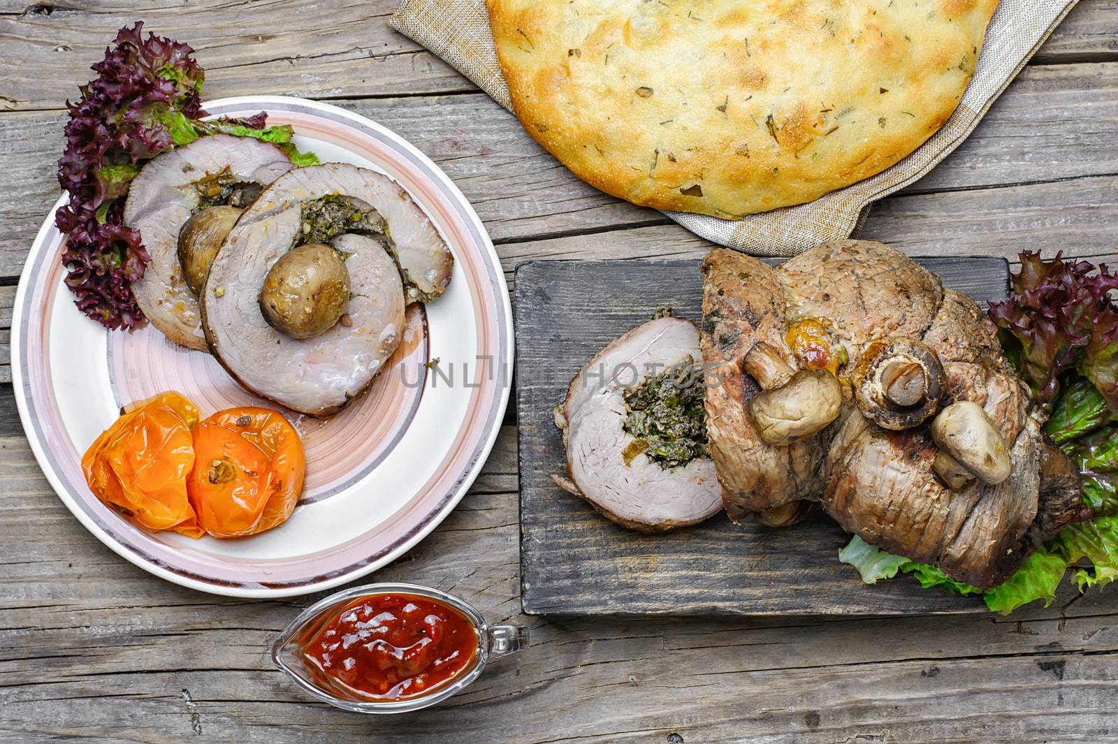 Dining table with meat loaf and pita bread