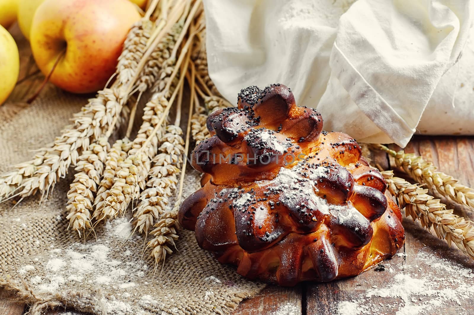 Still life with fresh homemade cakes,flour and ears of wheat