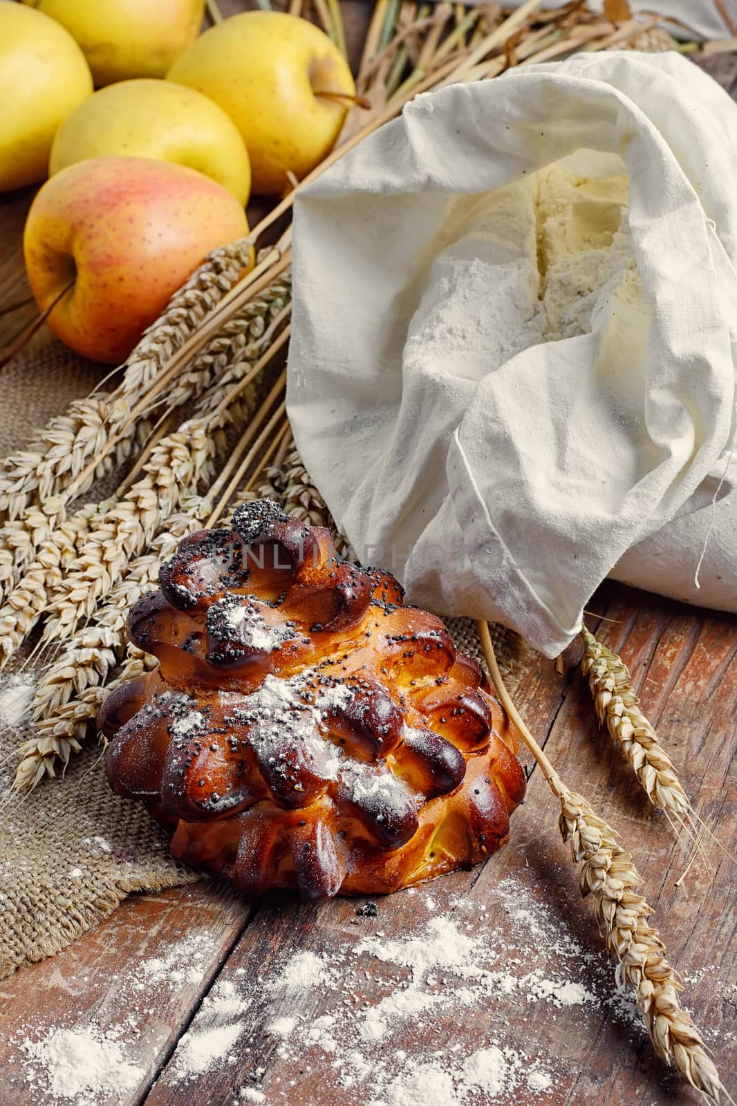 Still life with fresh homemade cakes,flour and ears of wheat