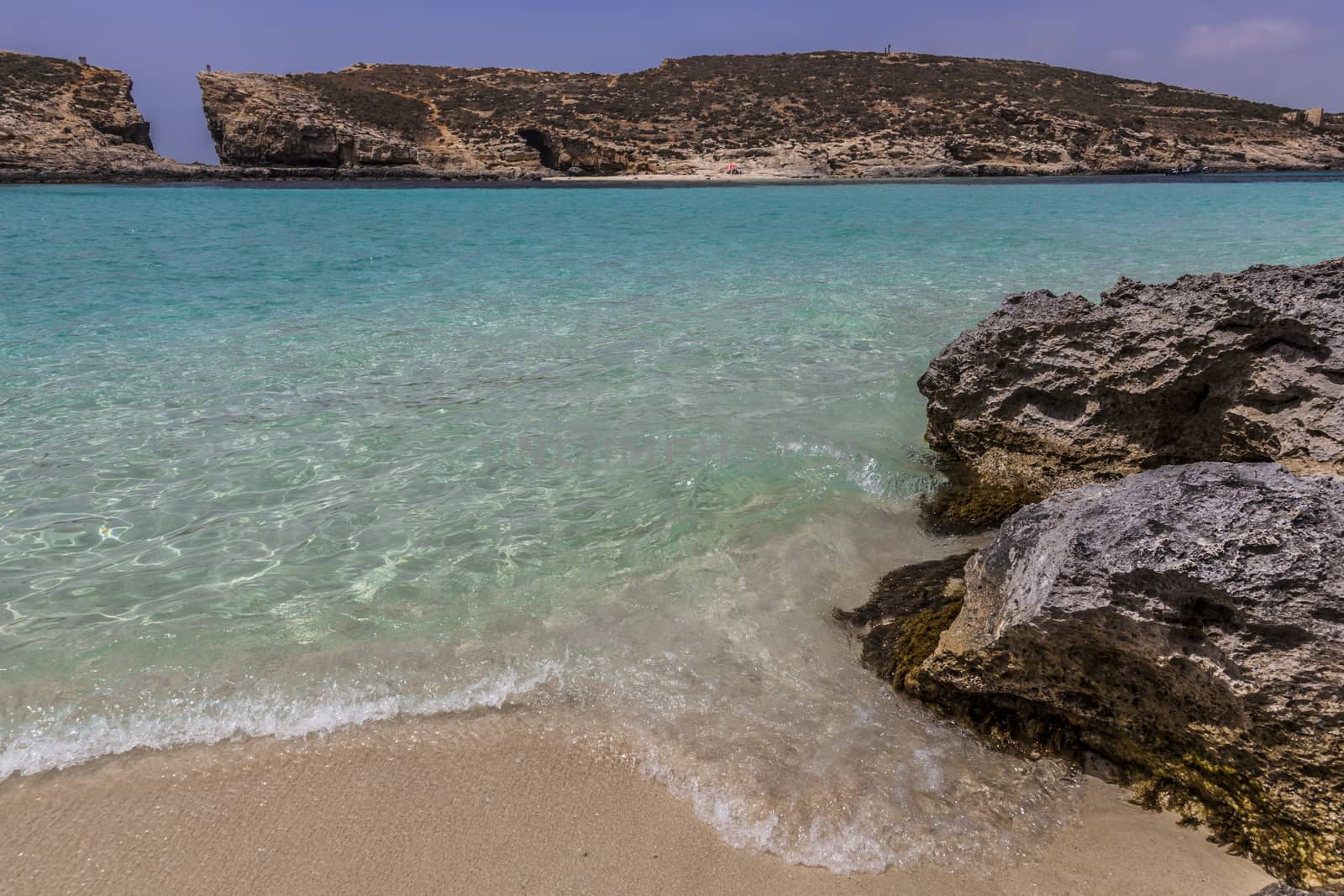 Rocks close to turquoise bright sea in Malta island