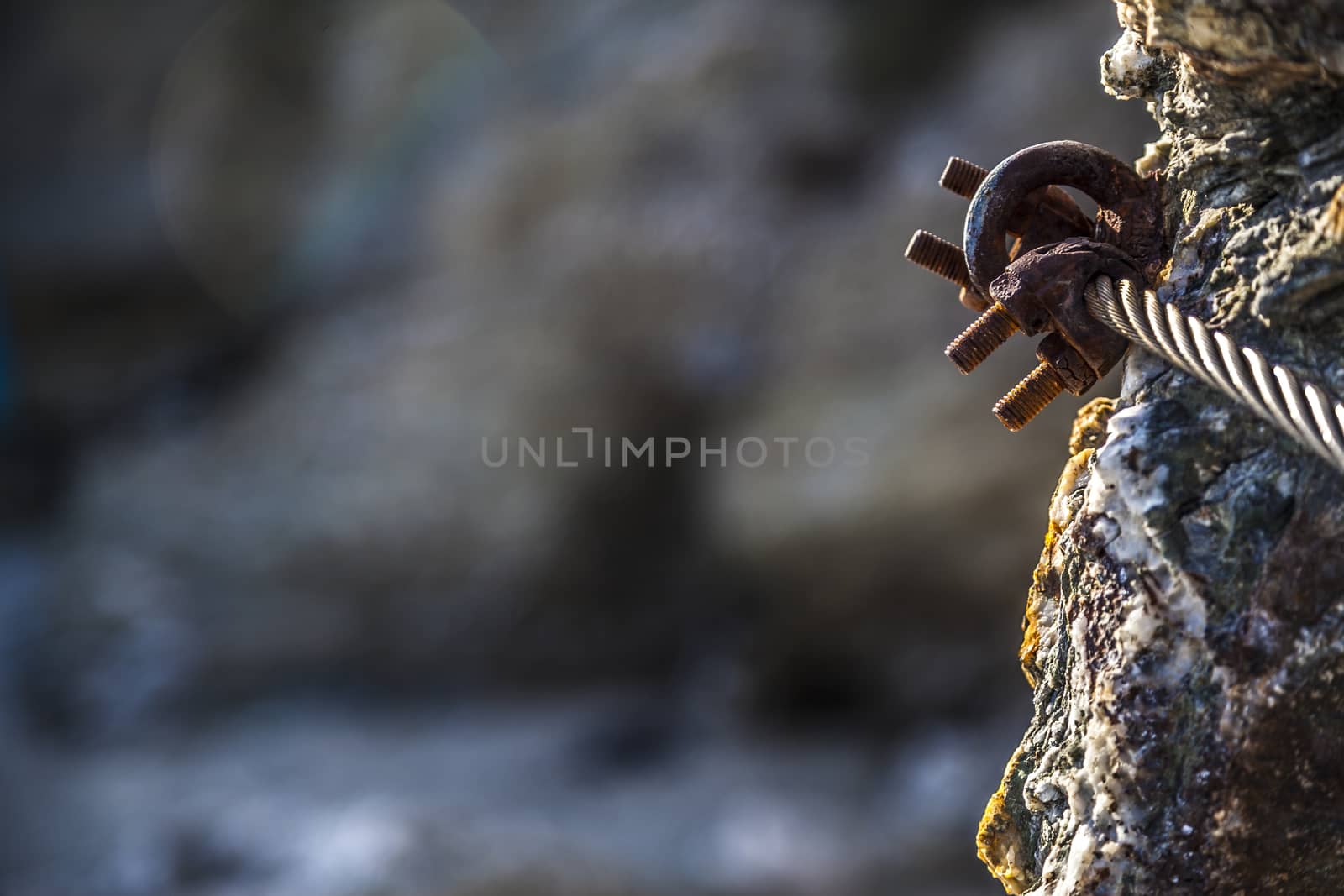 Rusty hook on sea rocks at french riviera