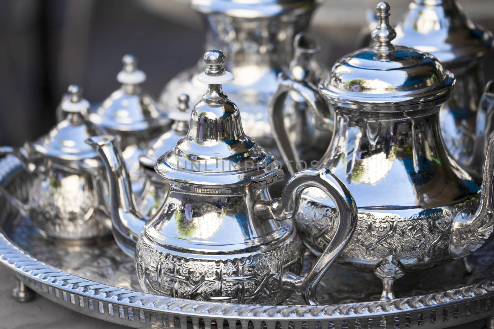 Table setting with silver tableware and dates. Oriental hospitality concept with tea or coffee cups