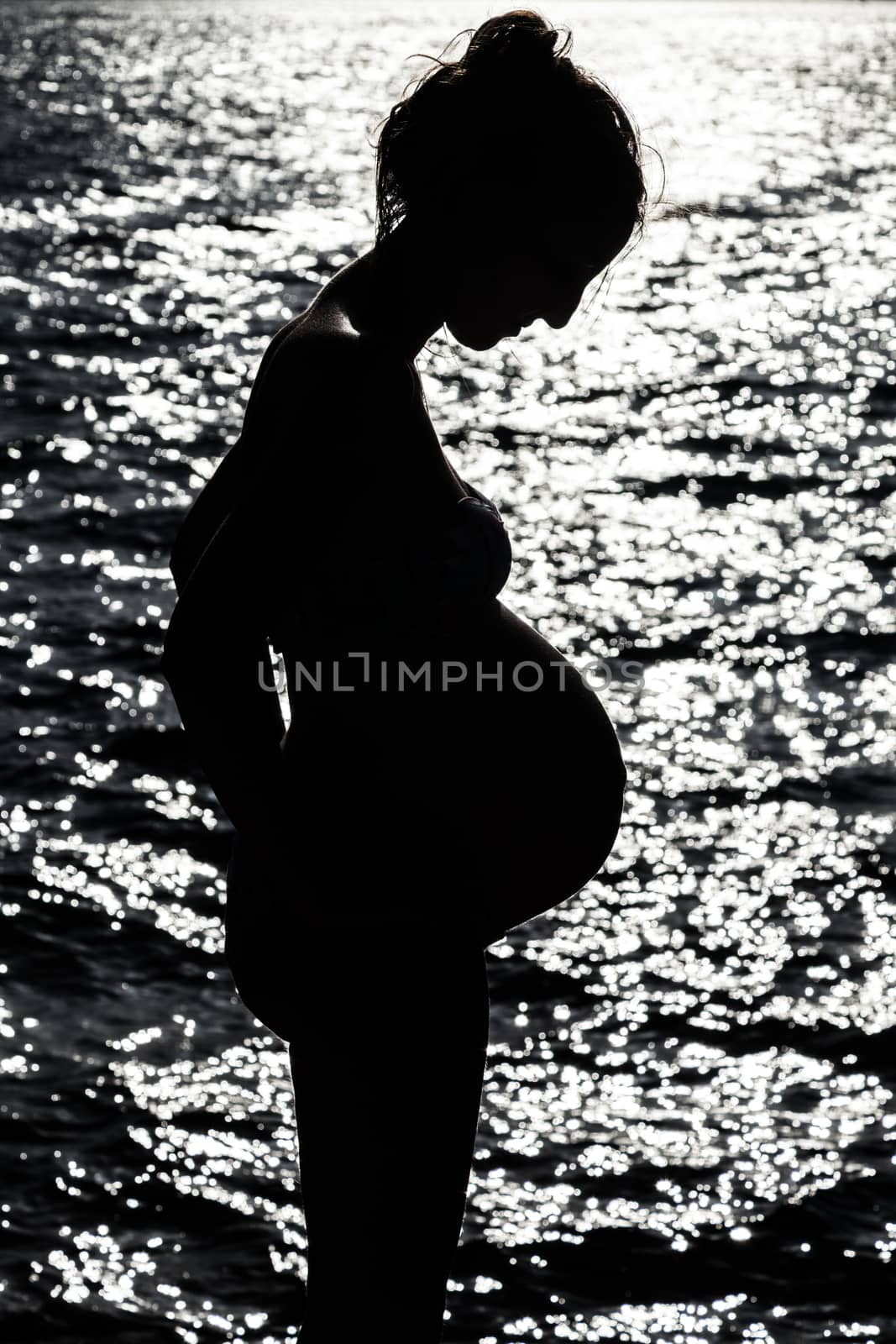 Silhouette of pregnant woman at the sunset at french riviera