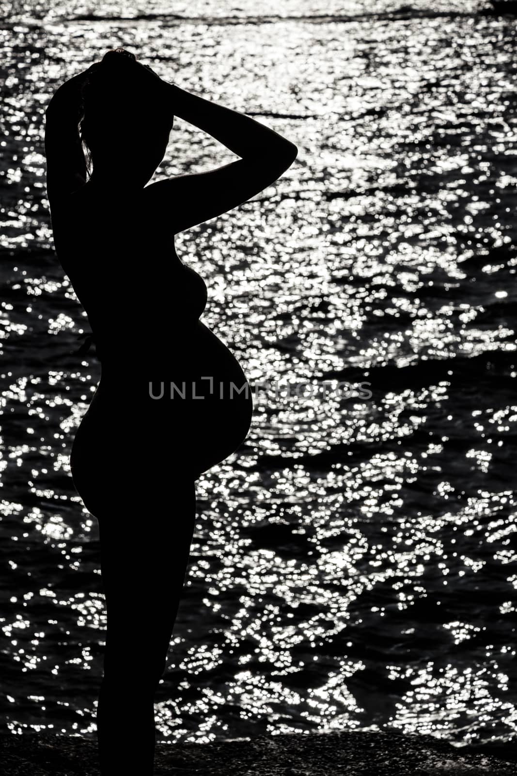 Silhouette of pregnant woman at the sunset at french riviera
