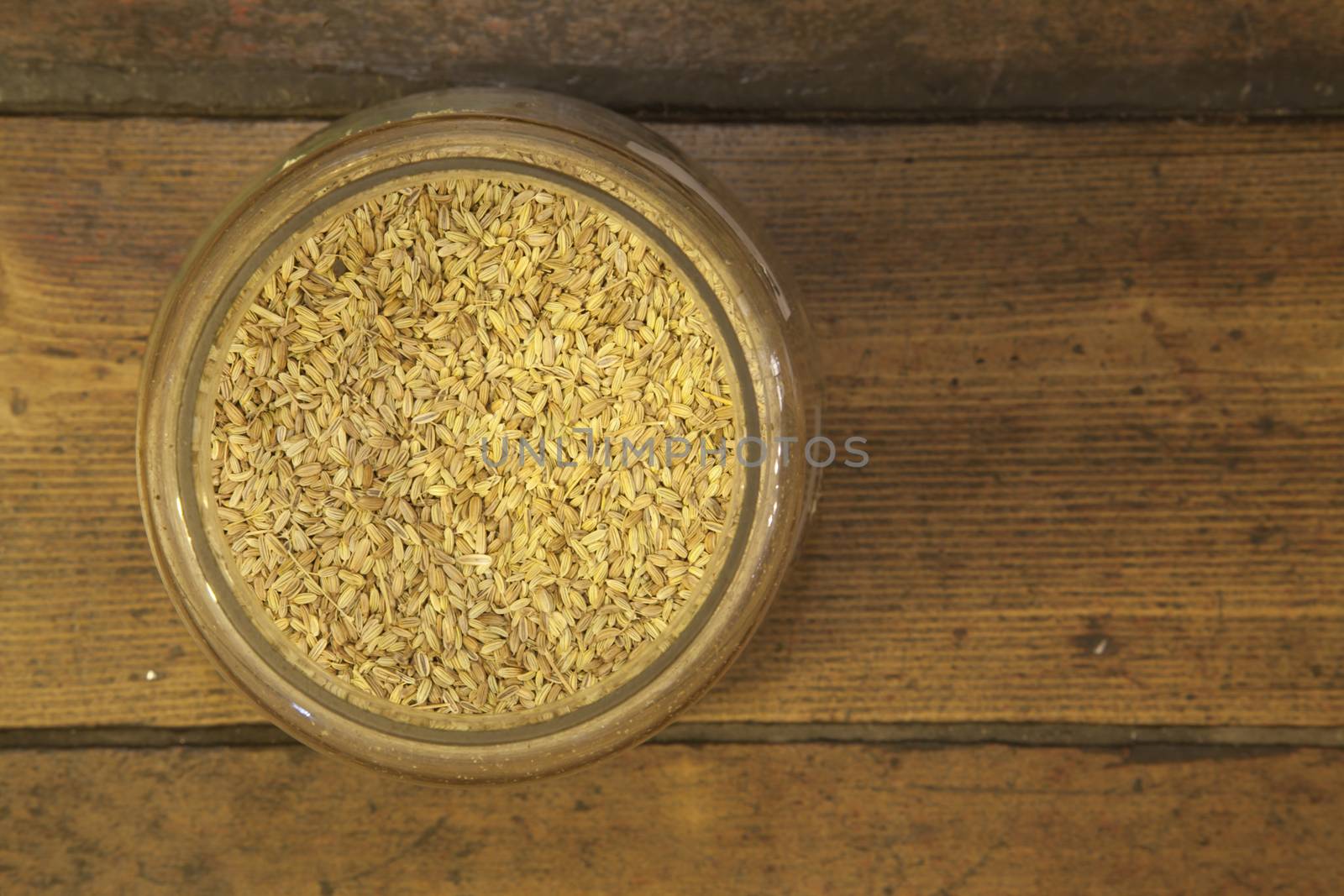 Open glass jar filled with mixed seeds