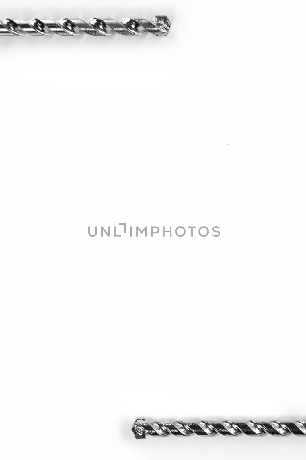 Drill bits of different sizes isolated over white background with copy space