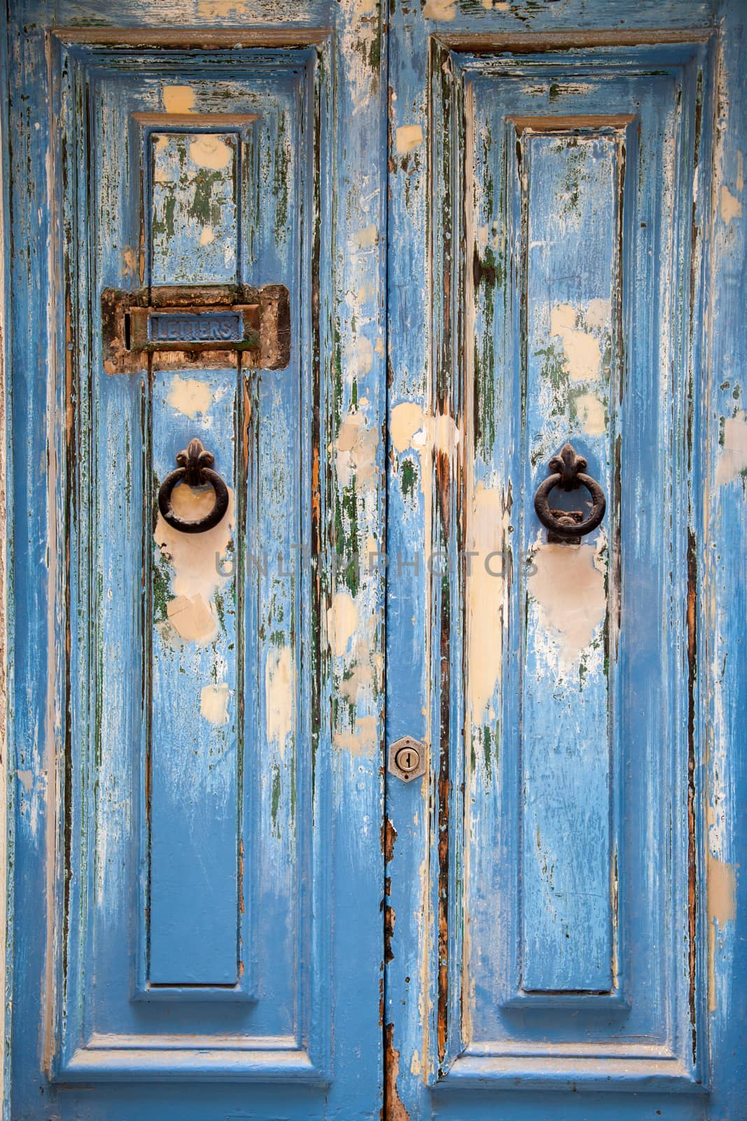 Blue weathered door with door knob and letter box