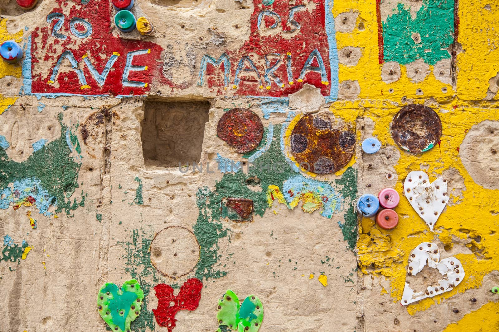 Hand painted wall with religious reference, bottle plugs and hearts