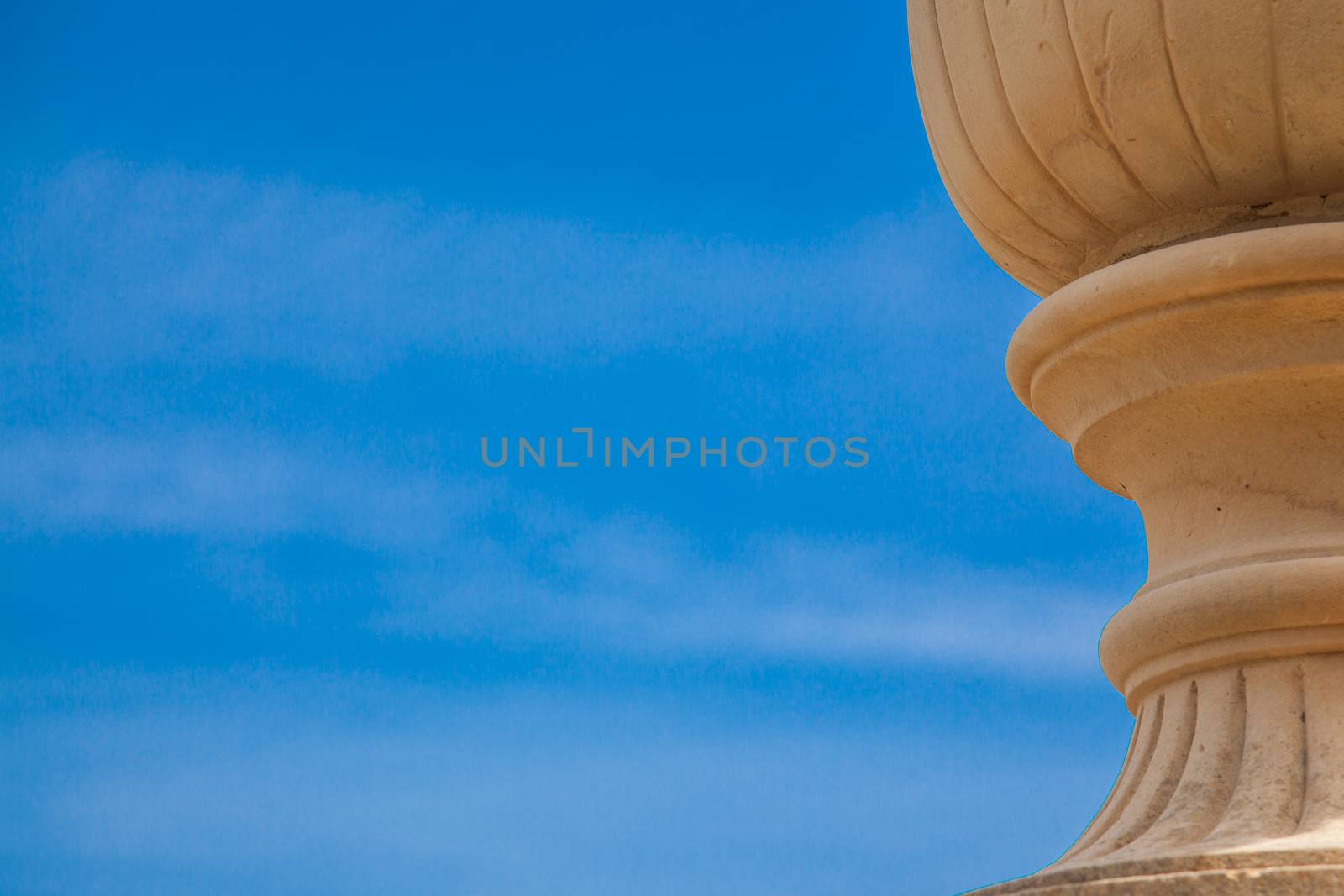 An ancient vase over a blue spring sky