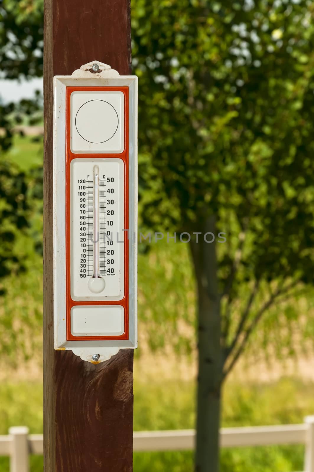 Vintage thermometer showing 75 degrees fahrenheit and 24 degrees Celsius