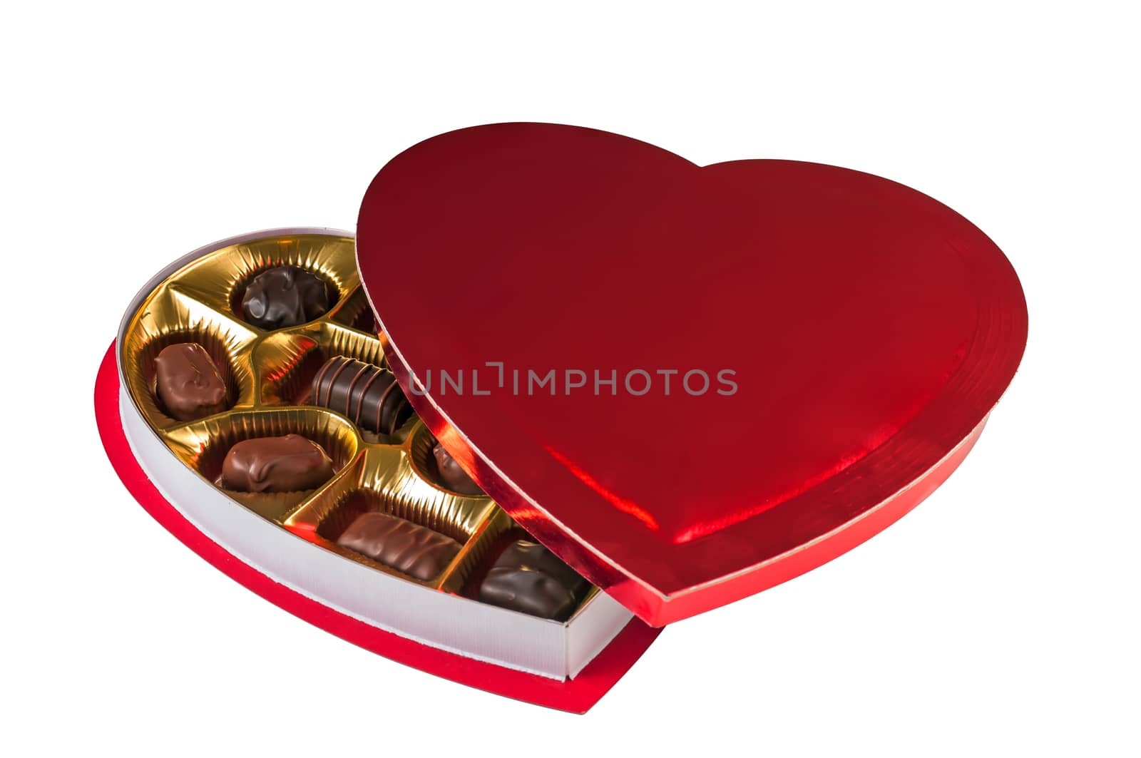 Assortment of chocolates in a heart shaped red box for a Valentine's day gift. Isolated on a white background with a clipping path