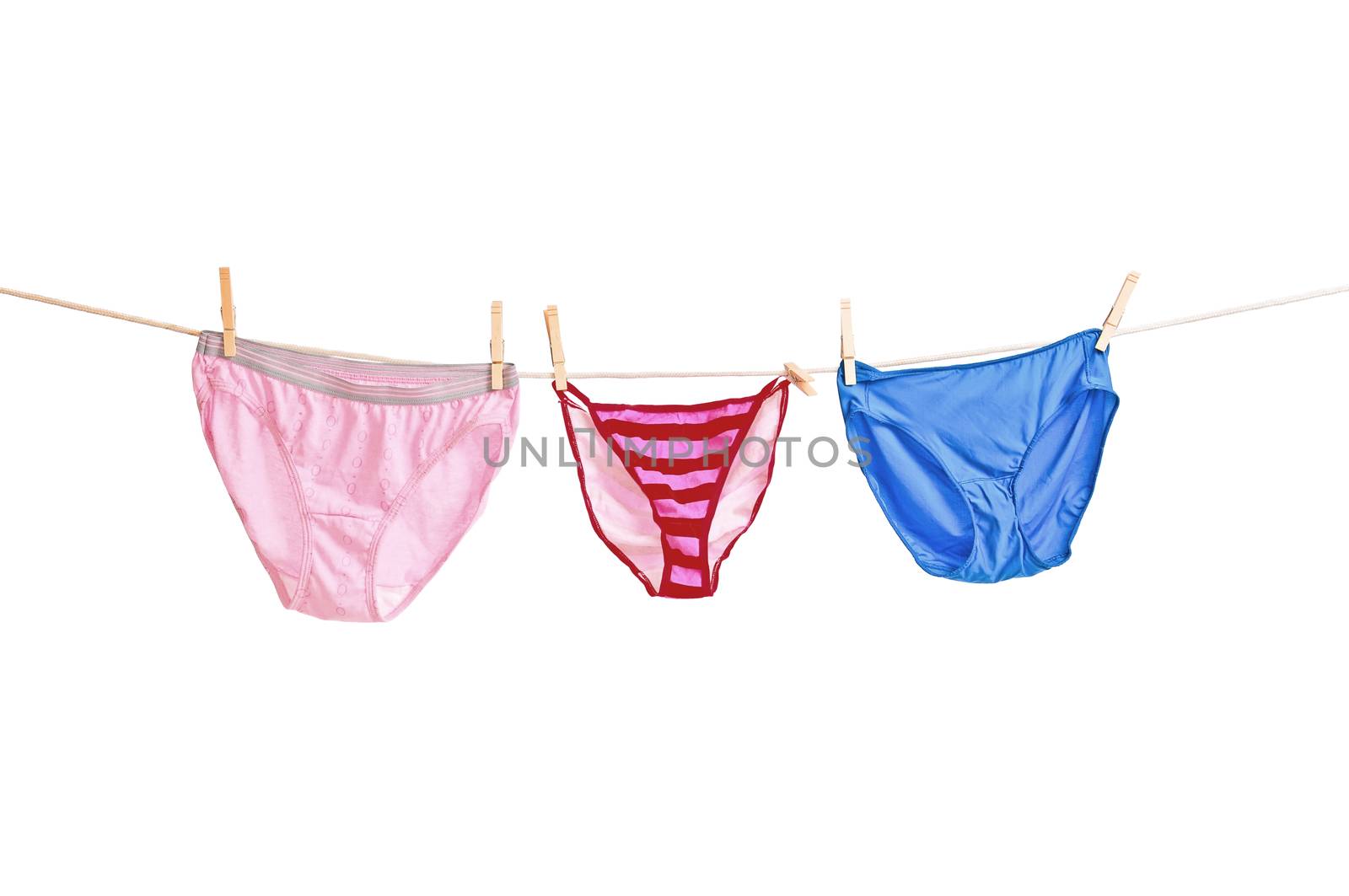 Three pair of womens panties hanging on a clothesline