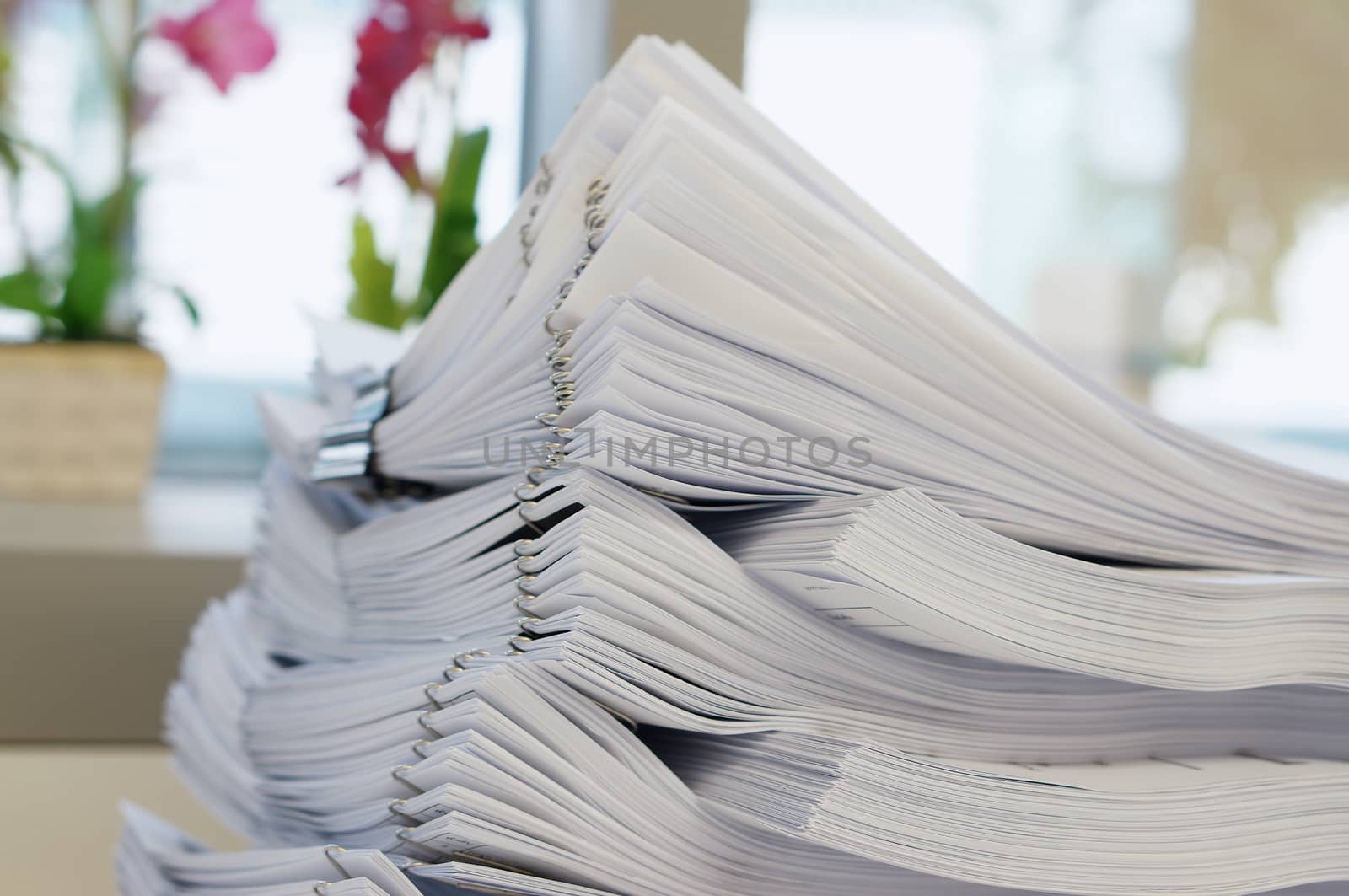 Stack of white document were put on desk at office.