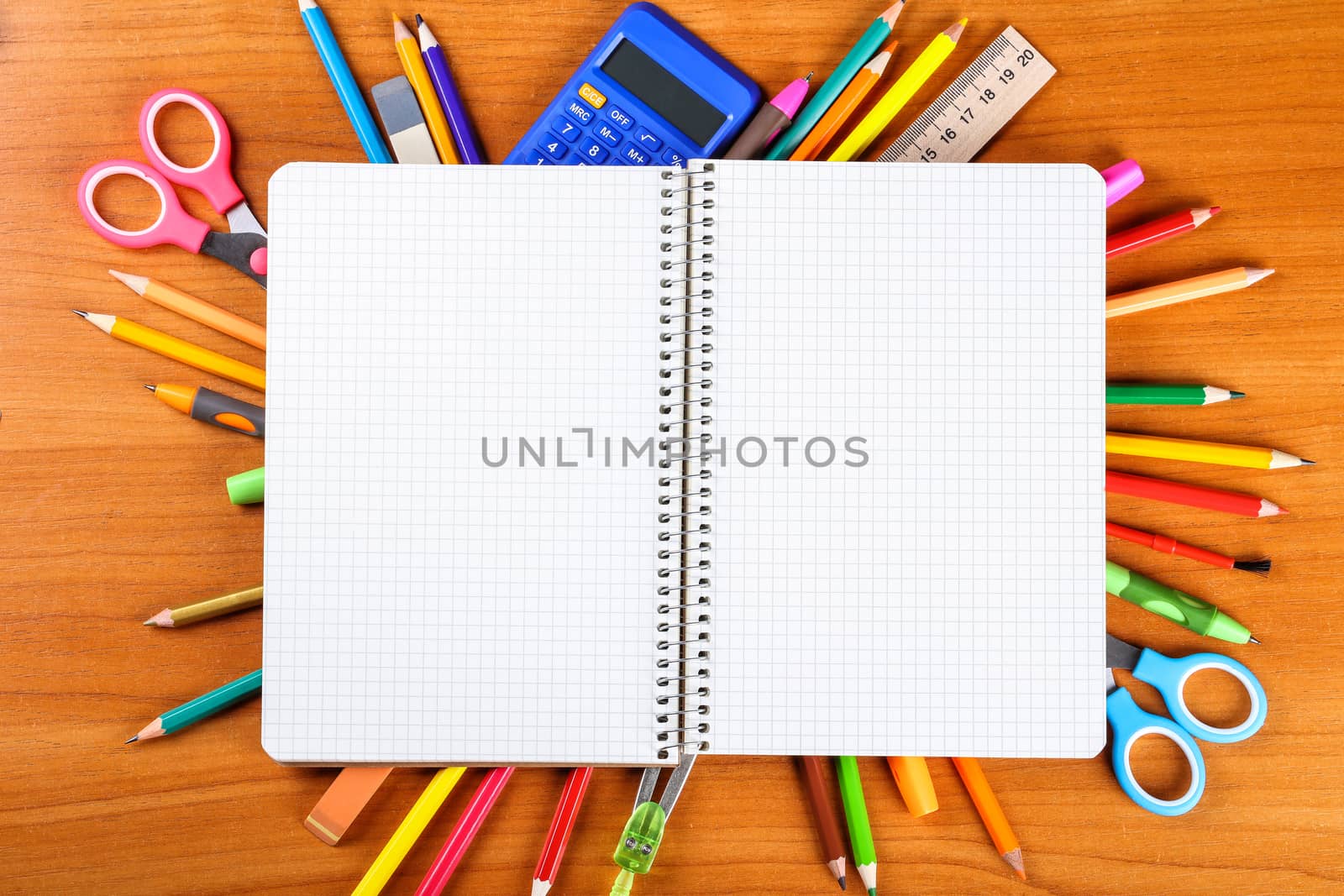 notebook, pencils, scissors, calculator, ruler, compass, pen on wooden background