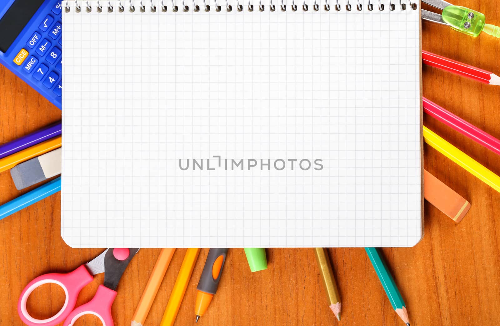 notebook, pencils, scissors, calculator, ruler, compass, pen on wooden background