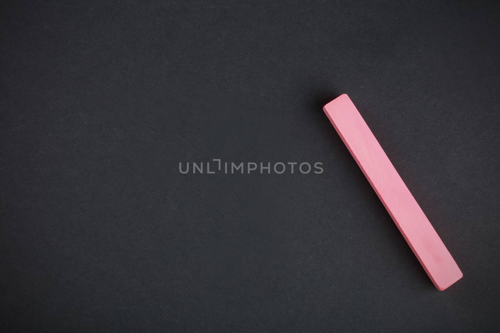 red chalk close-up against the black background