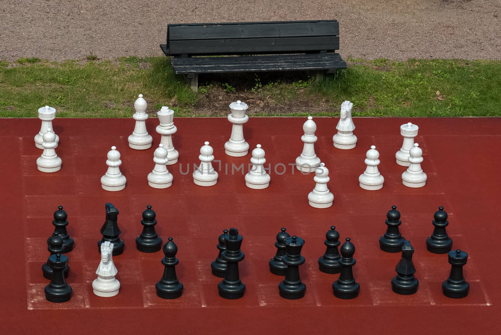 White and black chess pieces of large size for outdoor games.