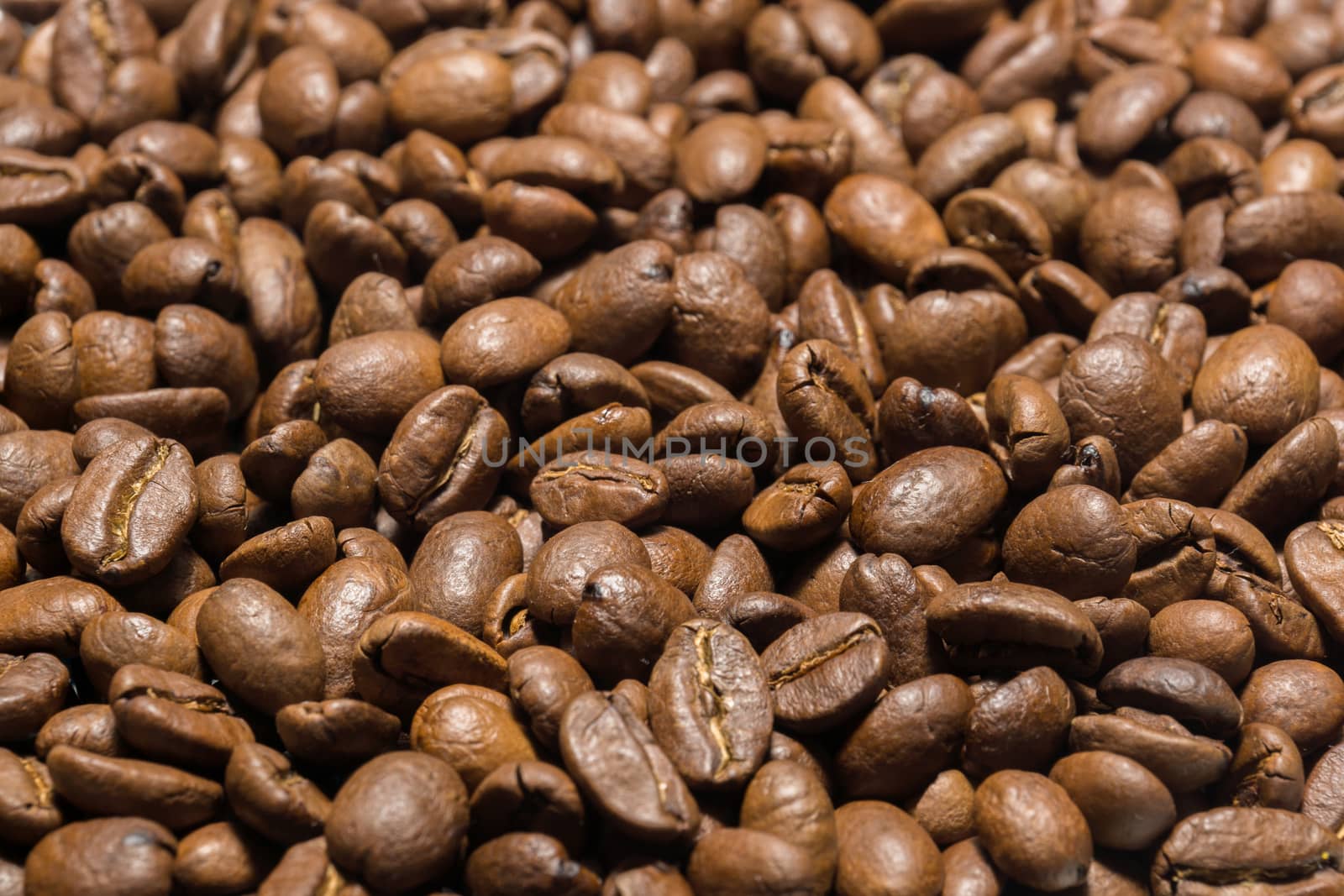 The photo shows roasted Arabica coffee beans