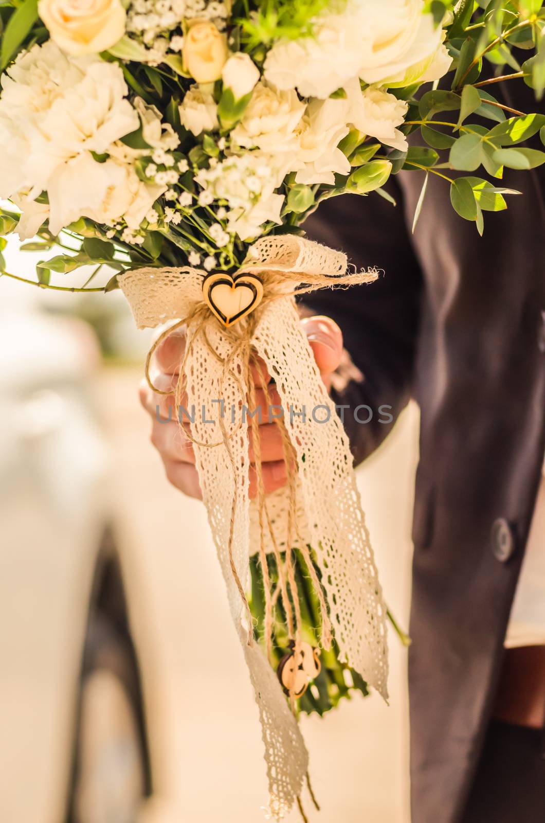 wedding bouquet in hands of the groom, decor heart