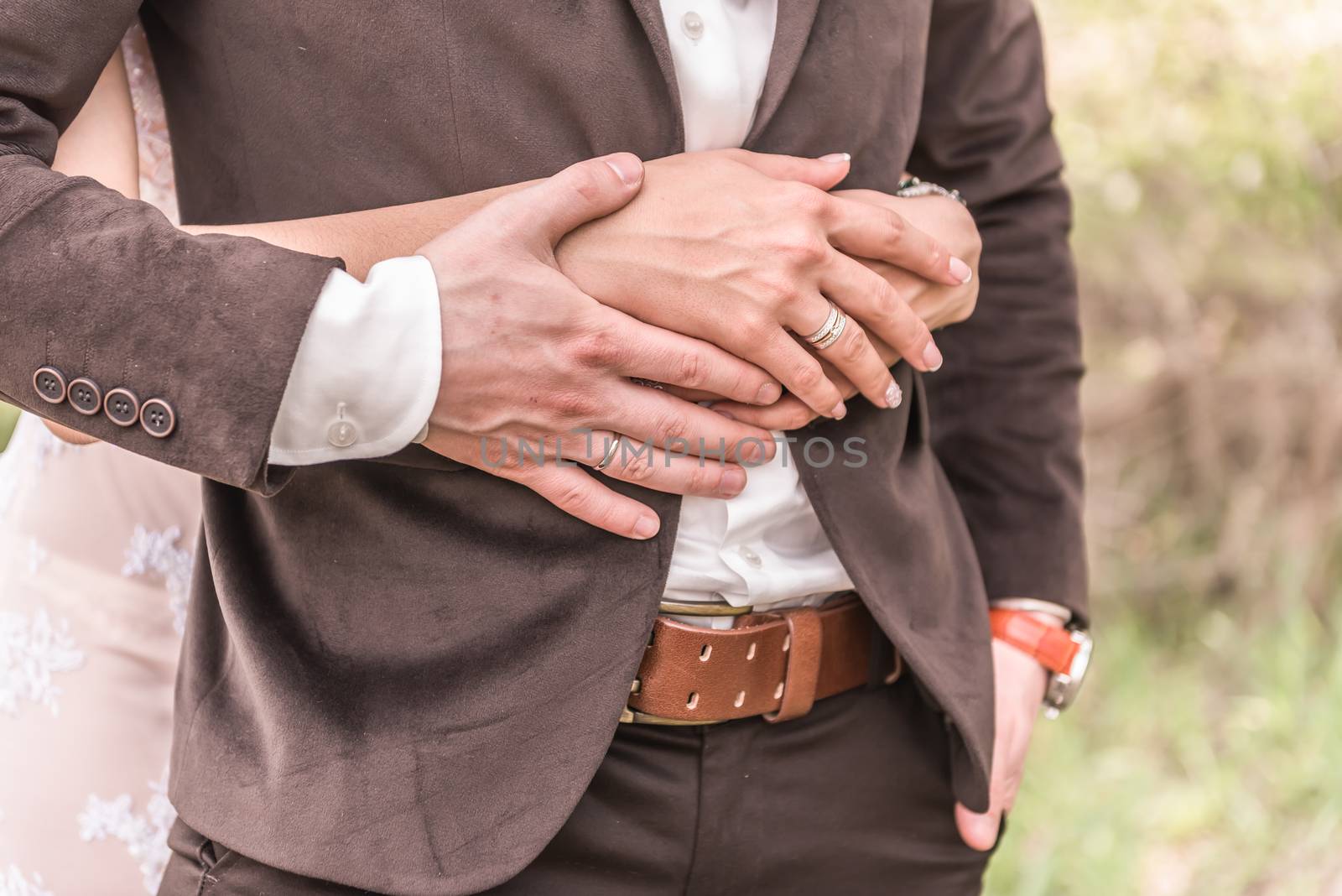 the bride and groom to hold hands, wedding rings