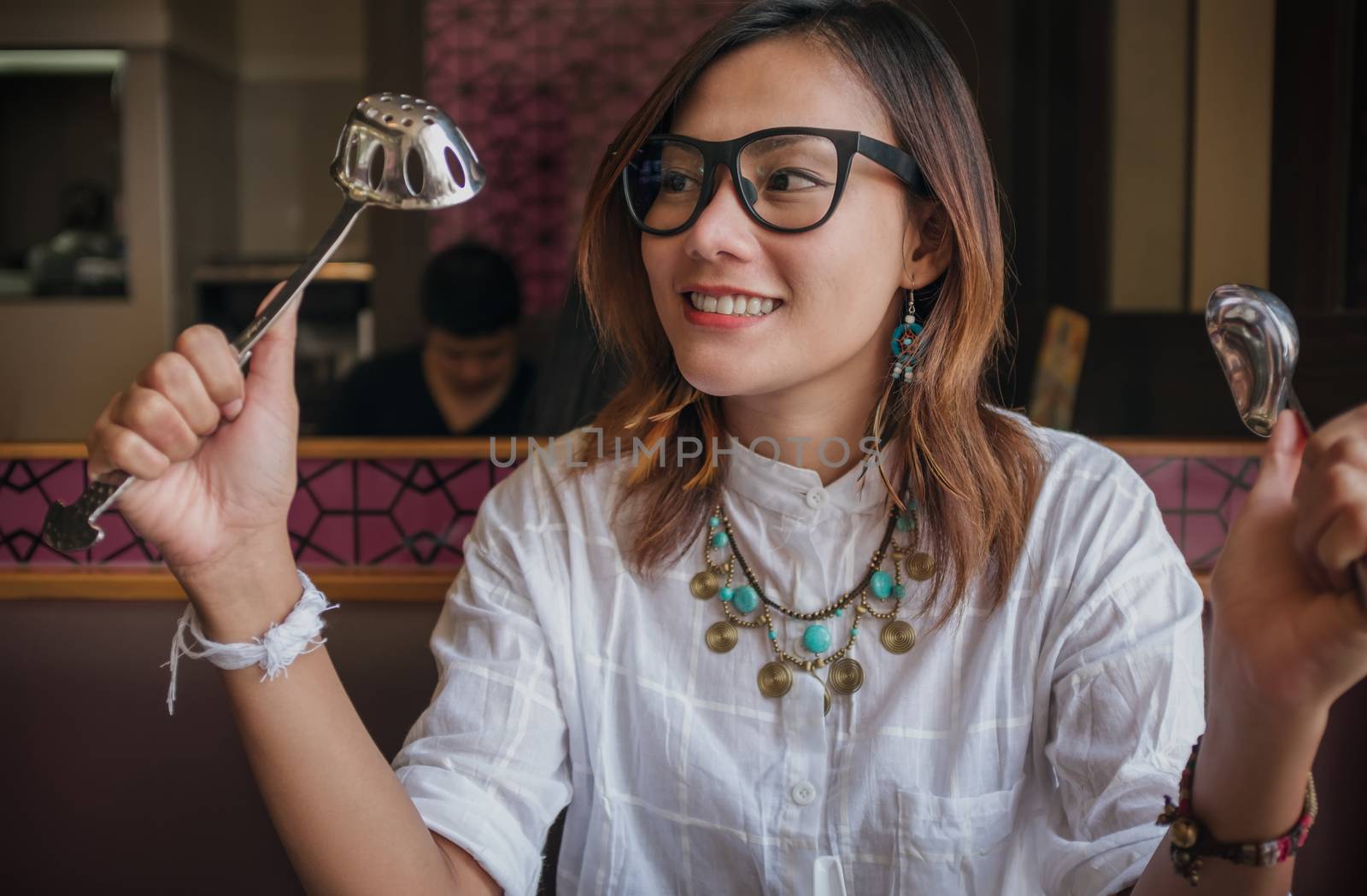 Woman holding  spoon with a happy mood. by PhairinThee