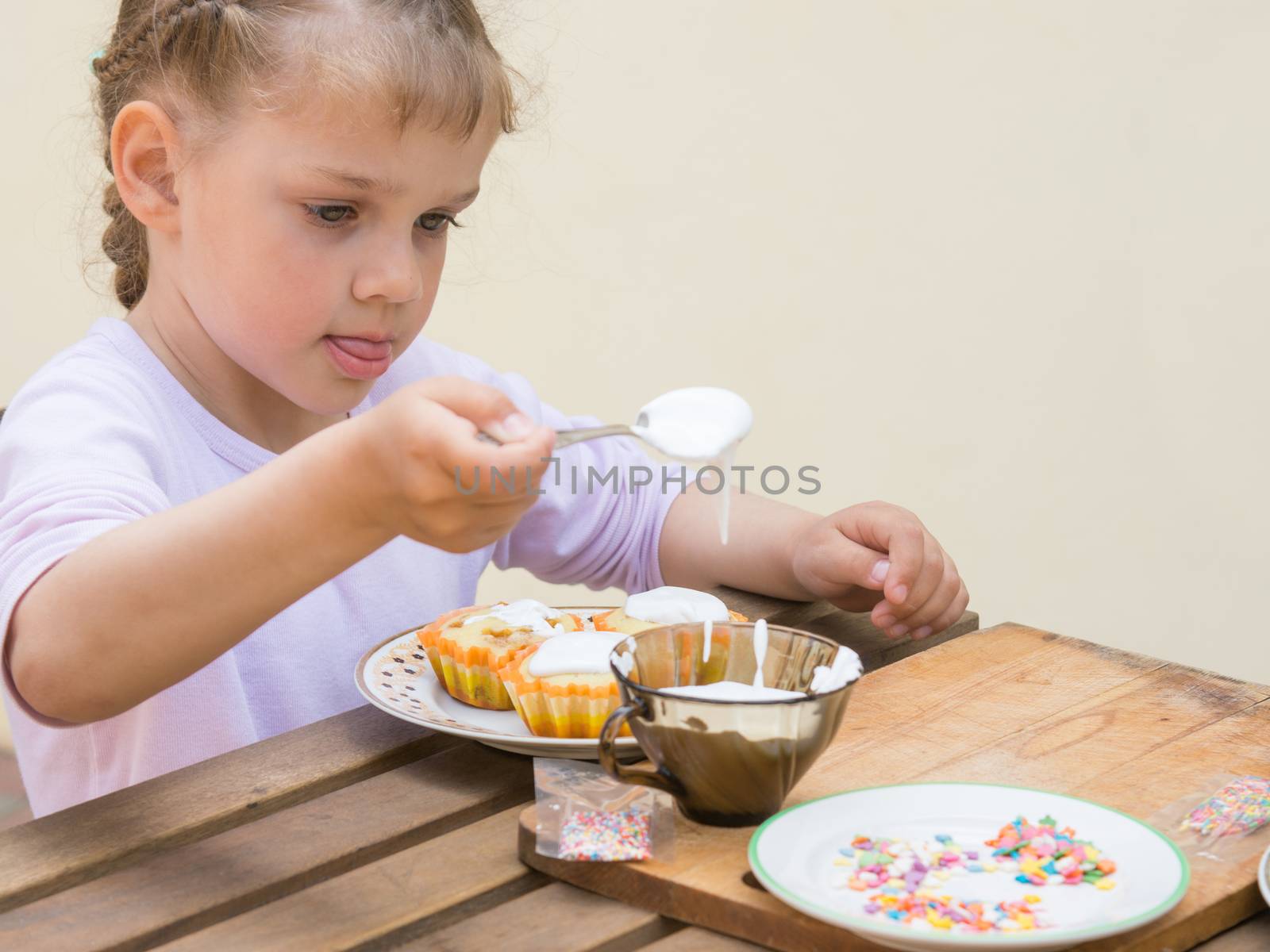 Girl puts focus on confectionery glaze Easter cupcakes