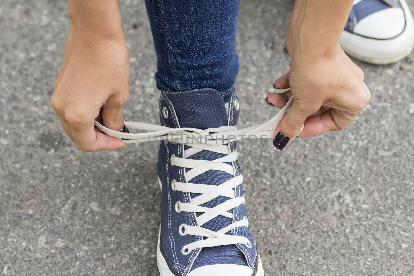 Hands girl knotted laces. by sergeizubkov64