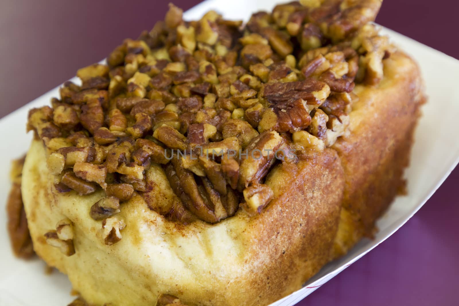 Freshly baked sweet roll topped with delicious pecan nuts and cinnamon.  Quick and delicious snack is fresh and tempting. 