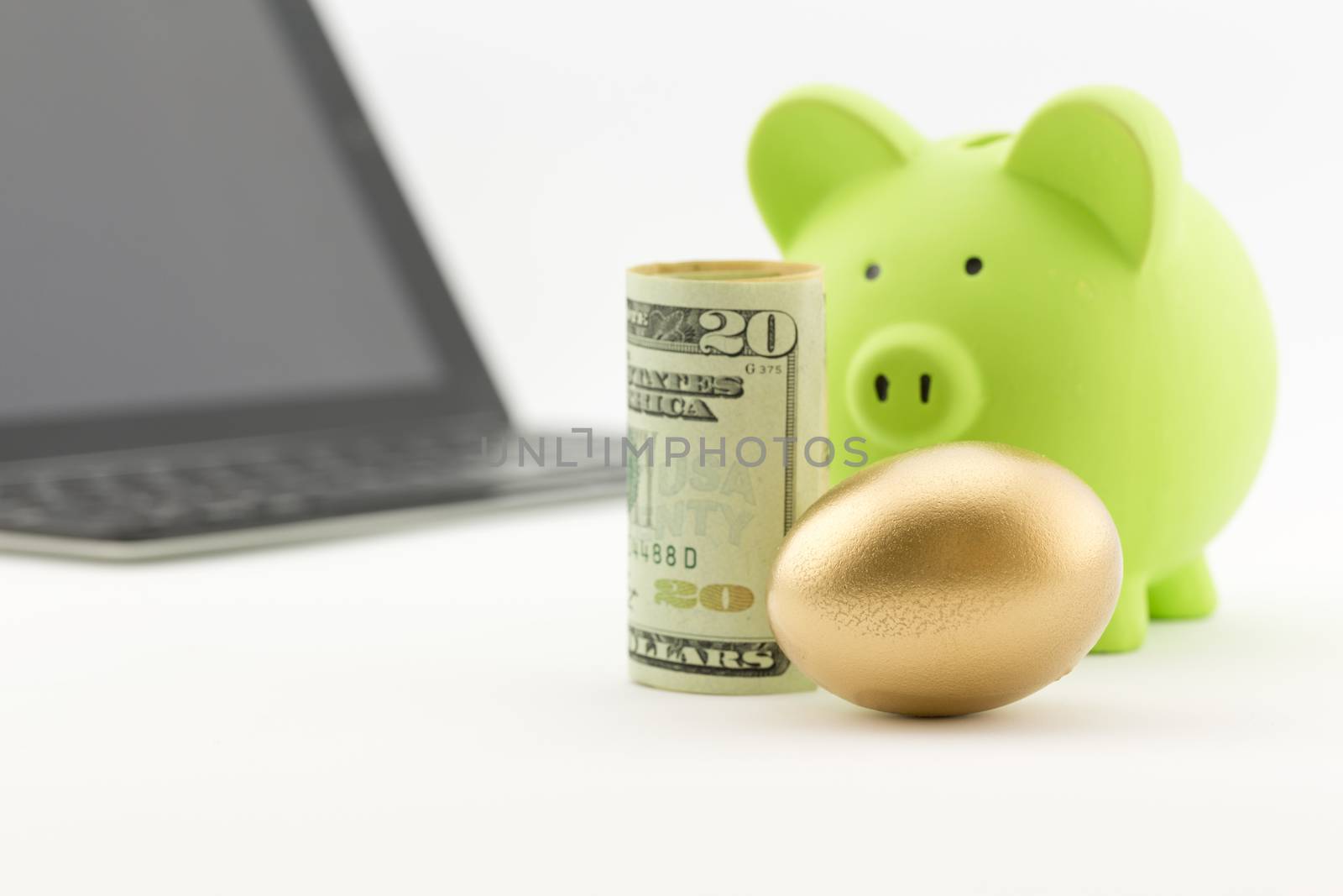 American currency placed with bank and gold nest egg reflects successful strategy of committed investment and savings.  Technology in background suggests modern, careful management. 