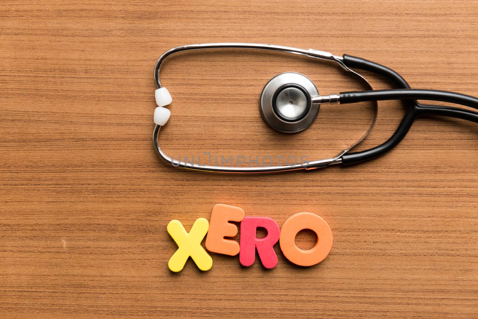 xero colorful word with stethoscope on wooden background