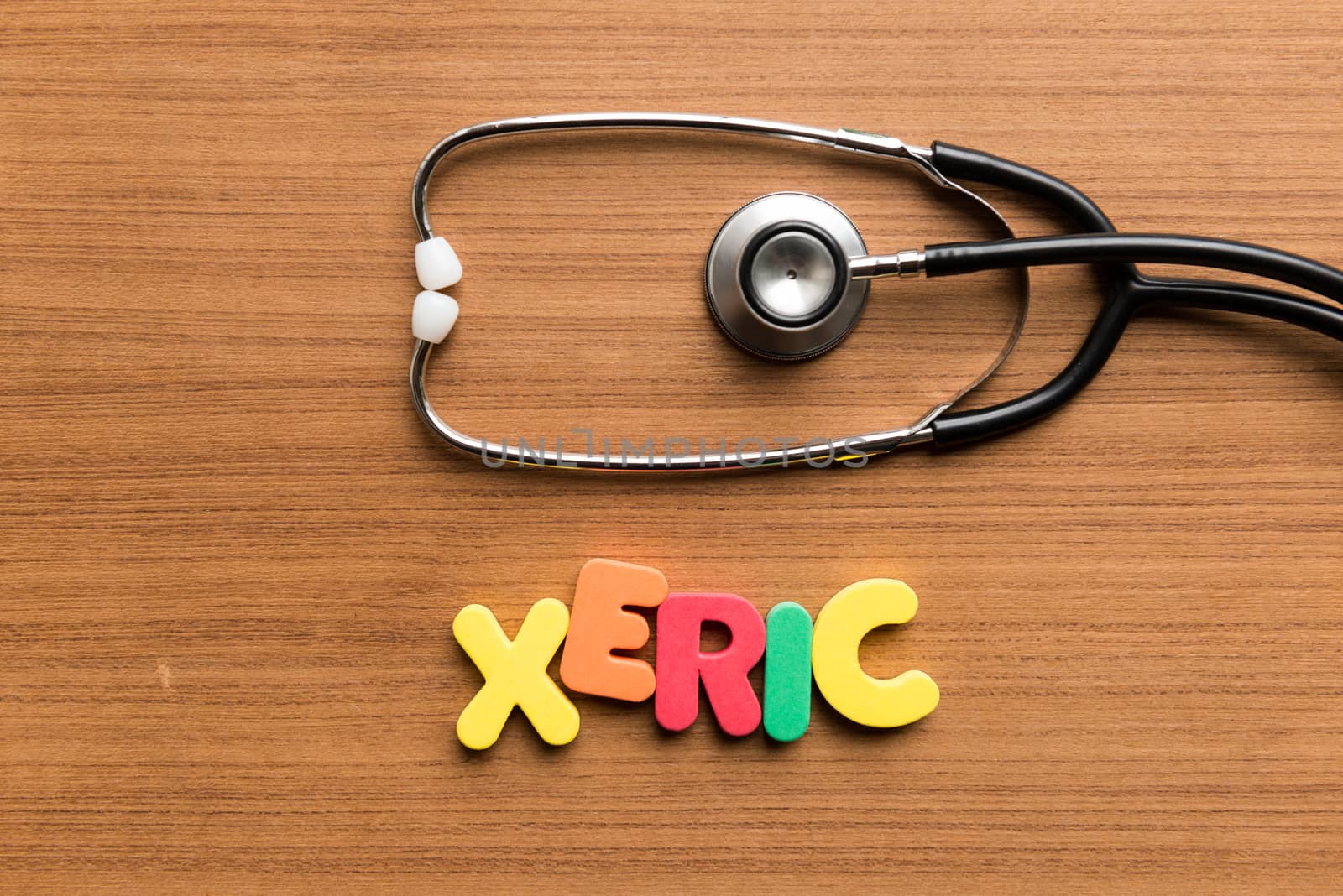 xeric colorful word with stethoscope on wooden background