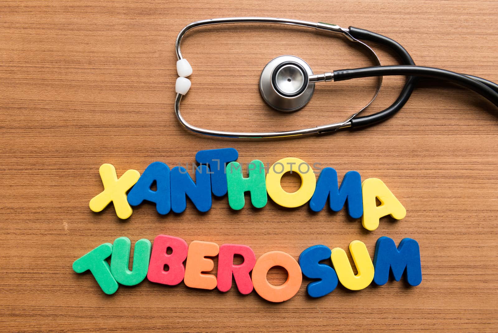 xanthoma tuberosum colorful word with stethoscope on wooden background