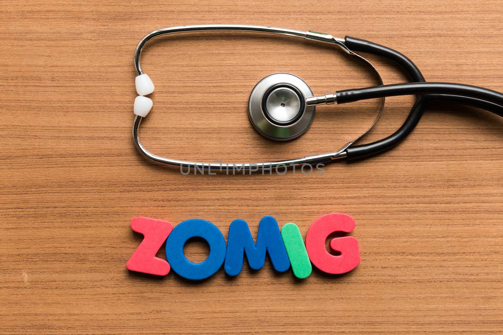 zomig colorful word with stethoscope on wooden background