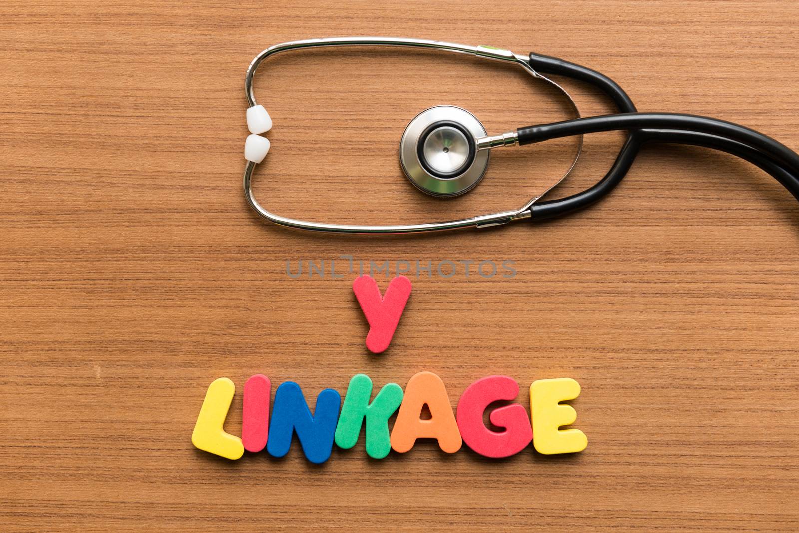 y linkage colorful word with stethoscope on wooden background