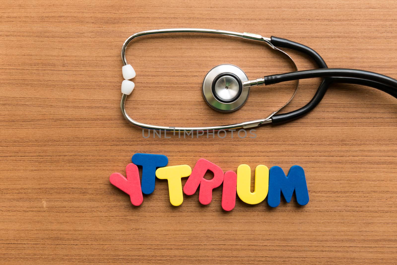 yttrium colorful word with stethoscope on wooden background