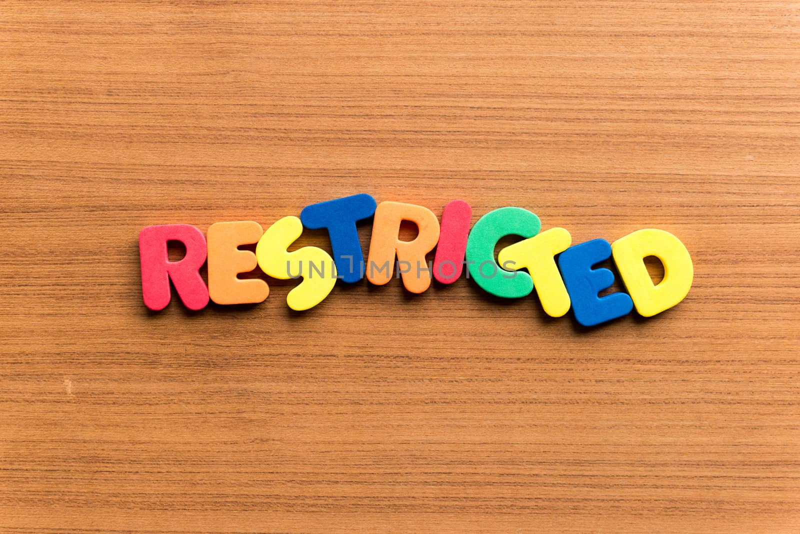 restricted colorful word on the wooden background