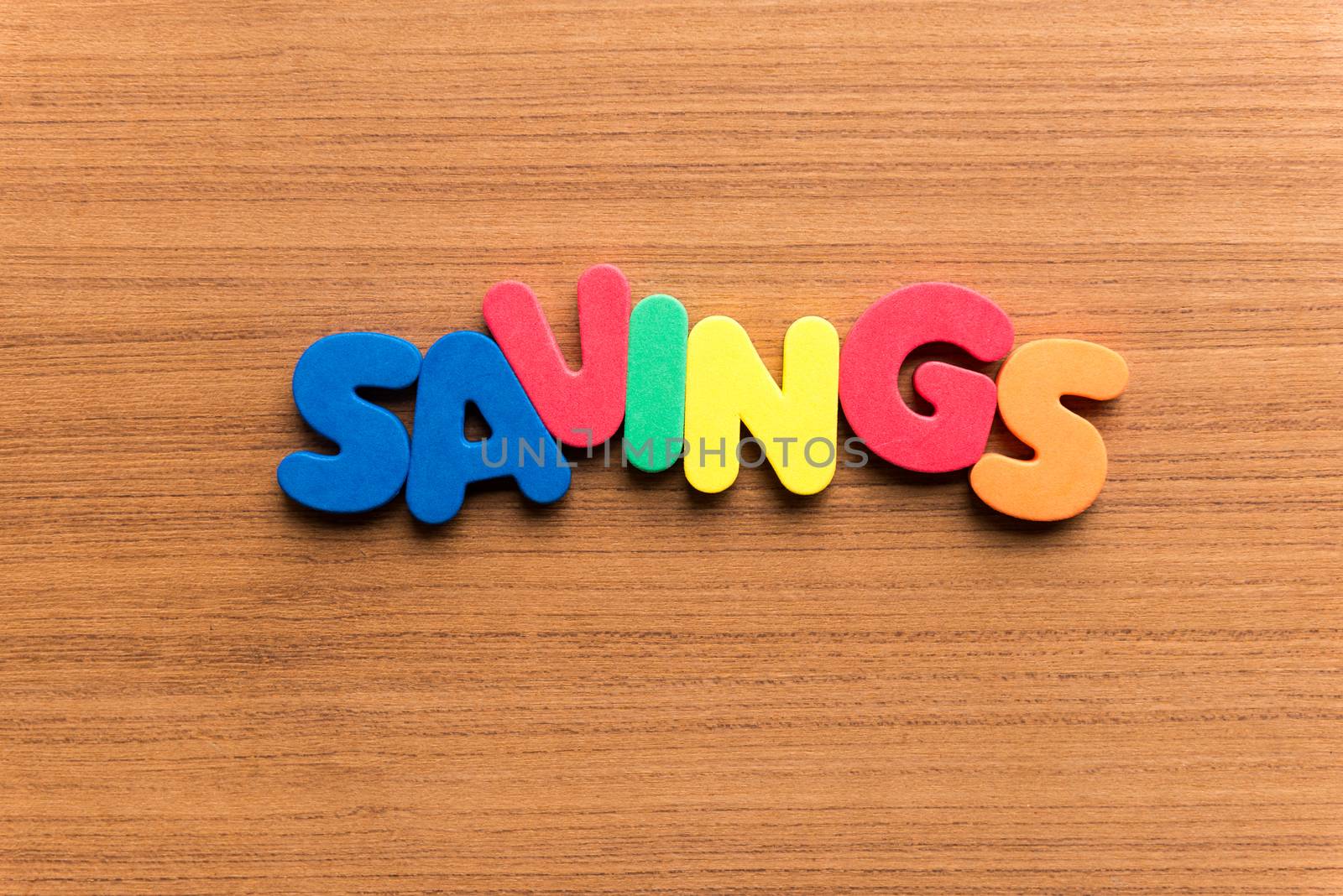 savings colorful word on the wooden background