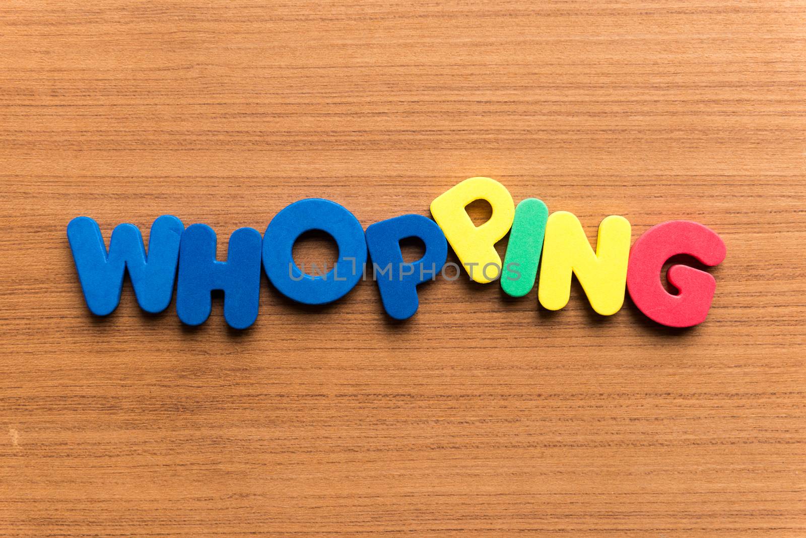 whopping colorful word on the wooden background