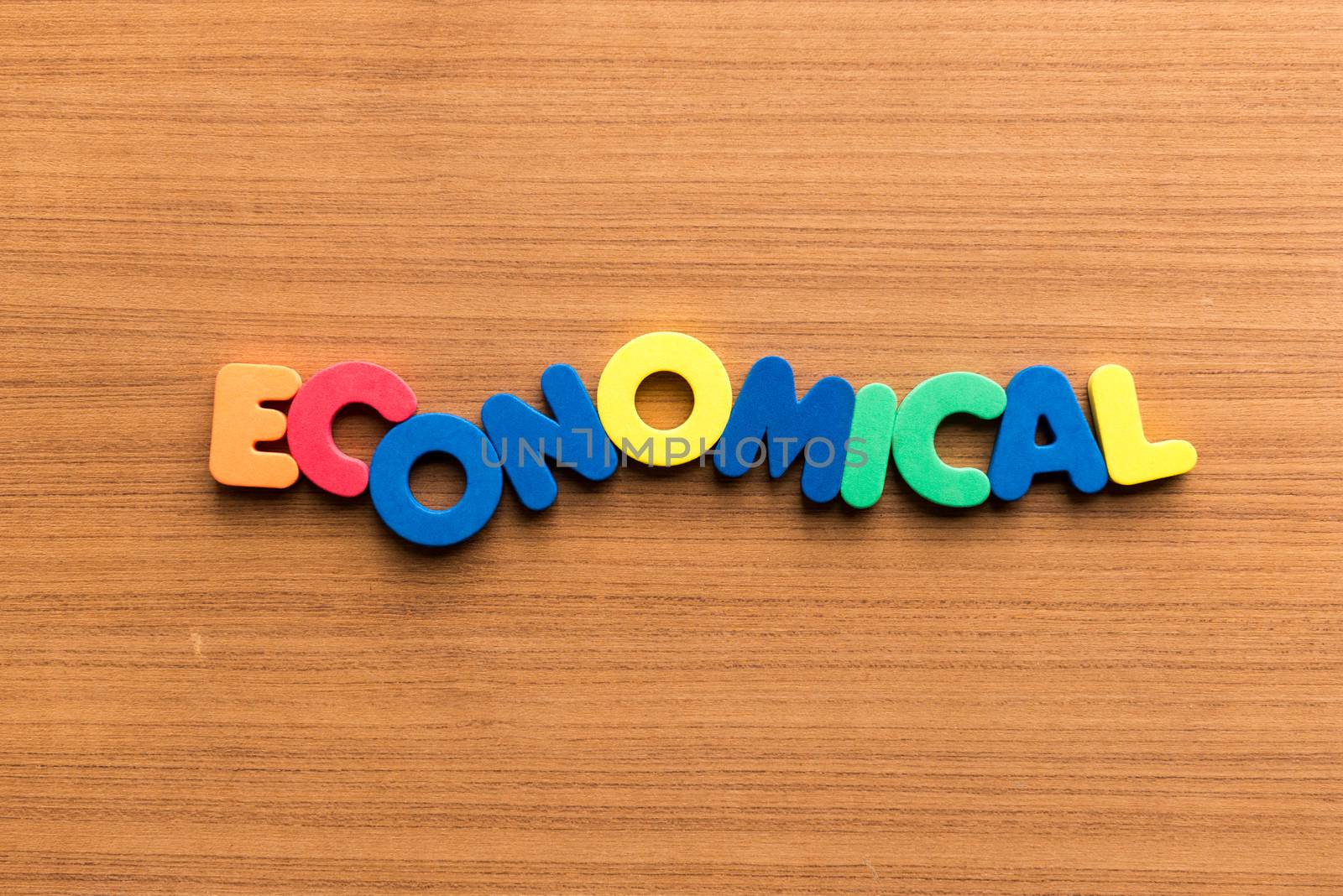 economical colorful word on the wooden background