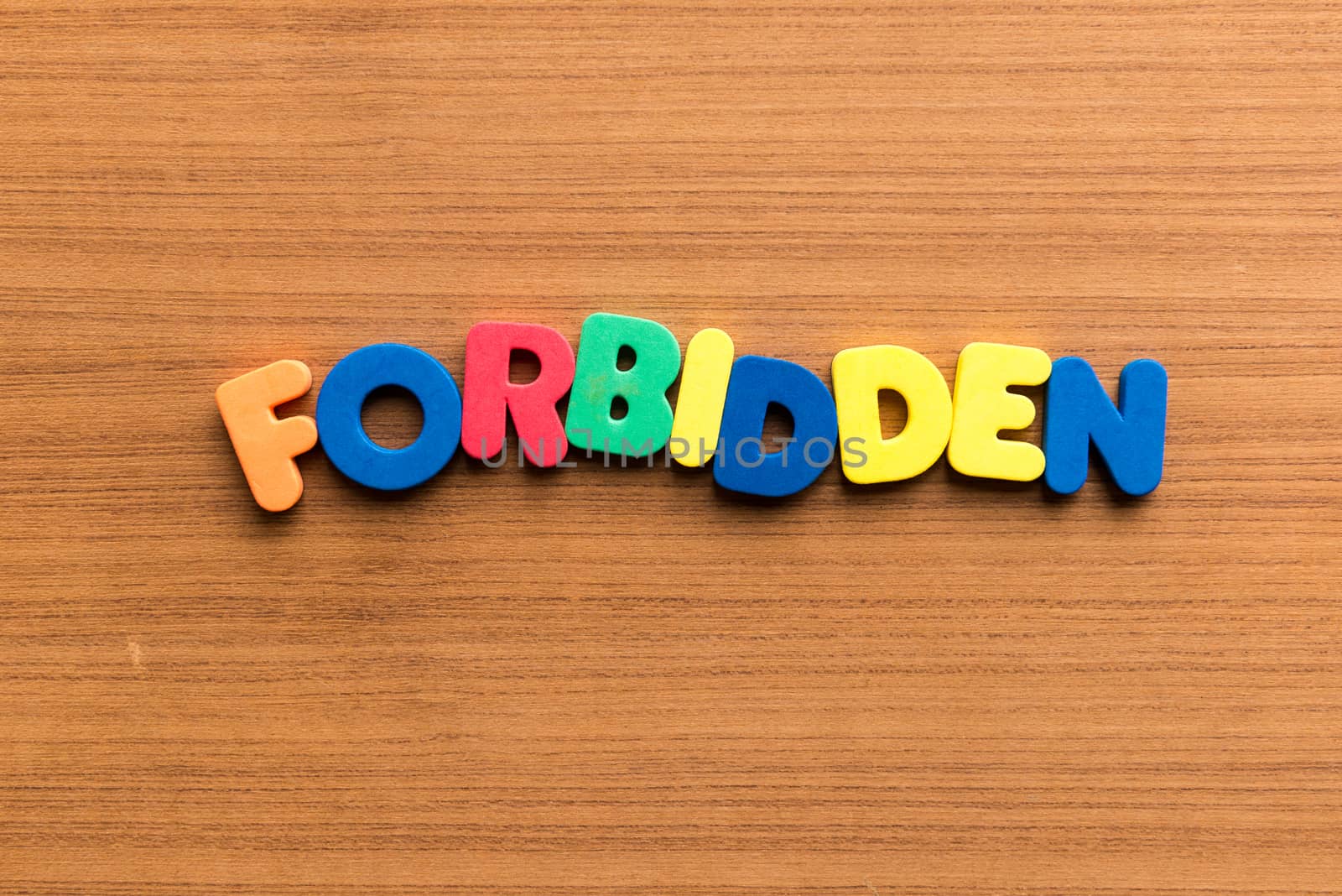 forbidden colorful word on the wooden background