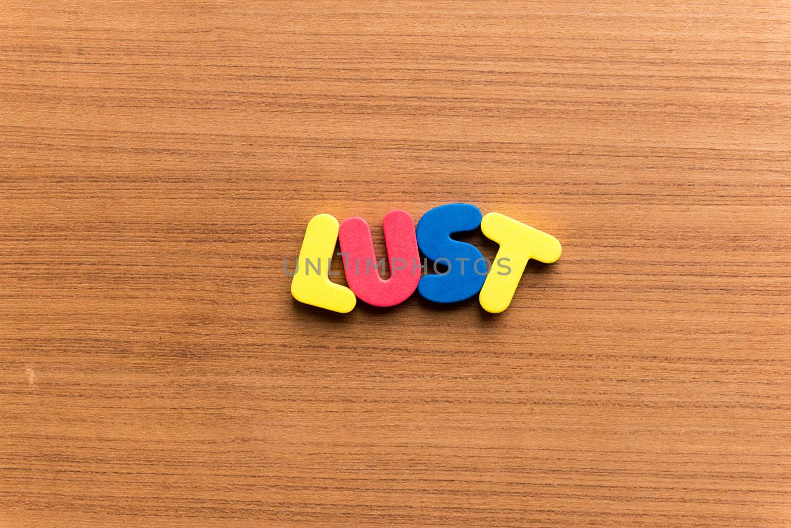 lust colorful word on the wooden background