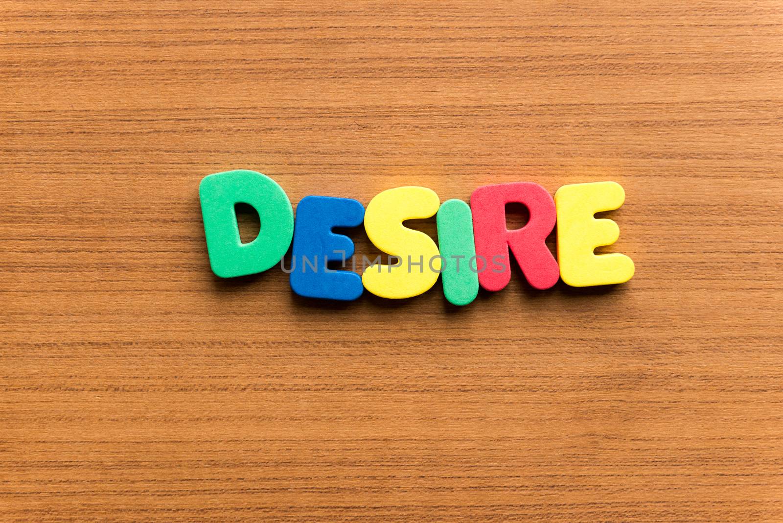 desire colorful word on the wooden background