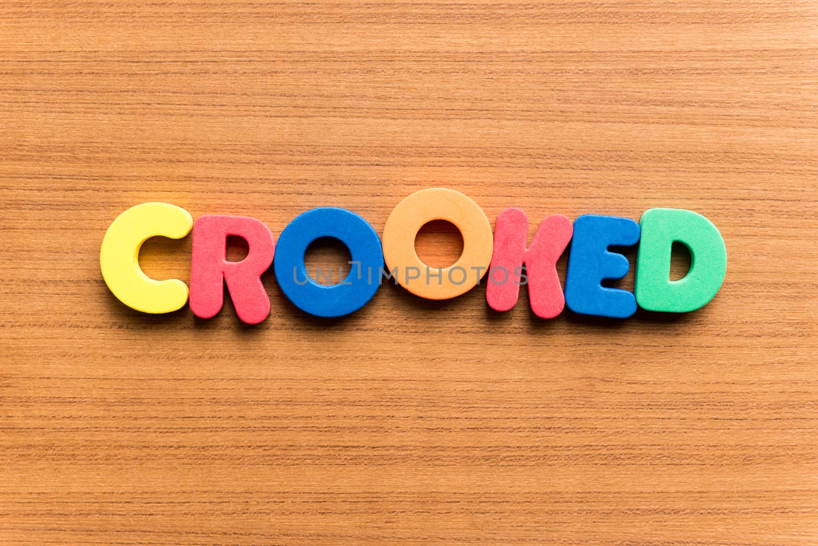 crooked colorful word on the wooden background
