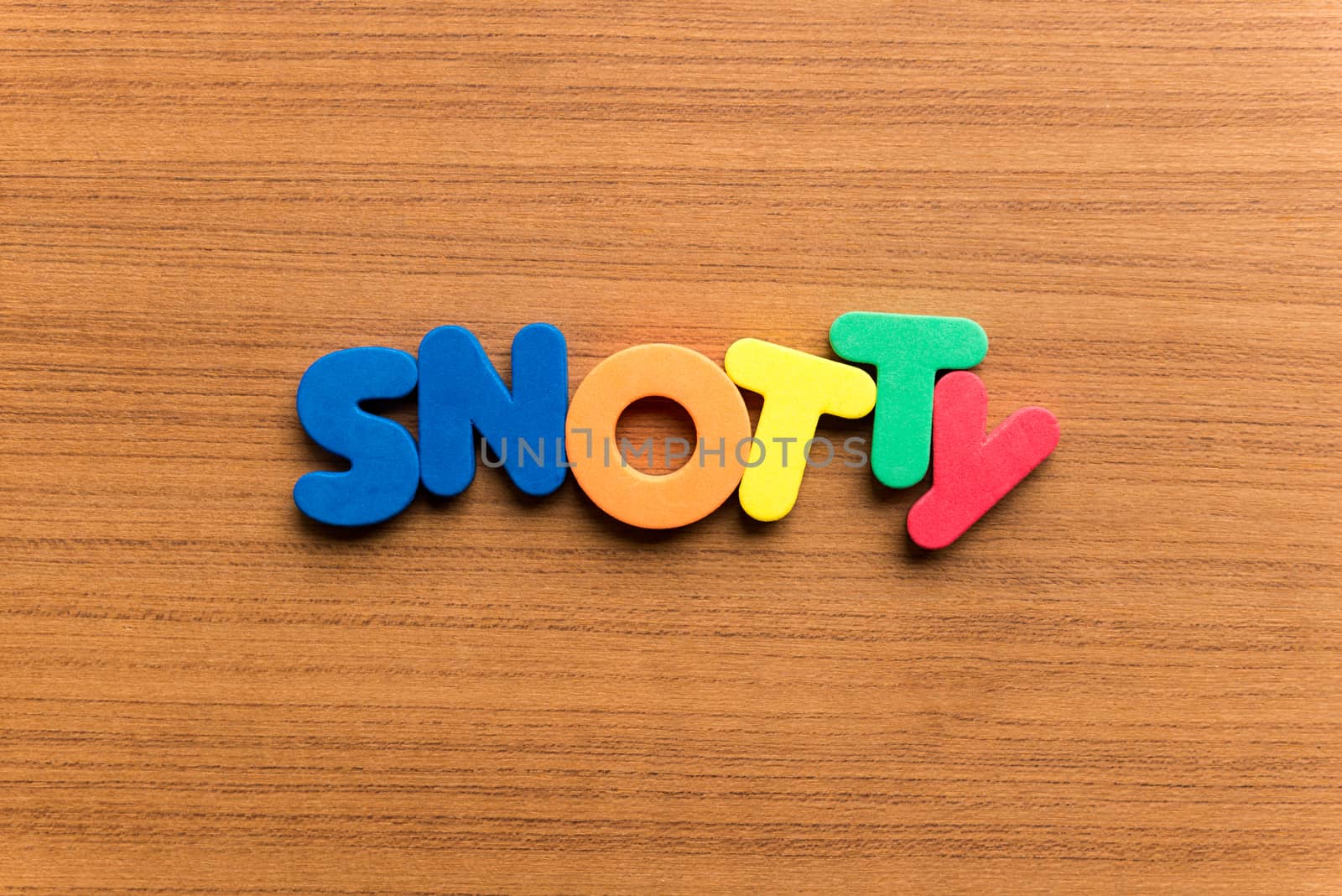 snotty colorful word on the wooden background